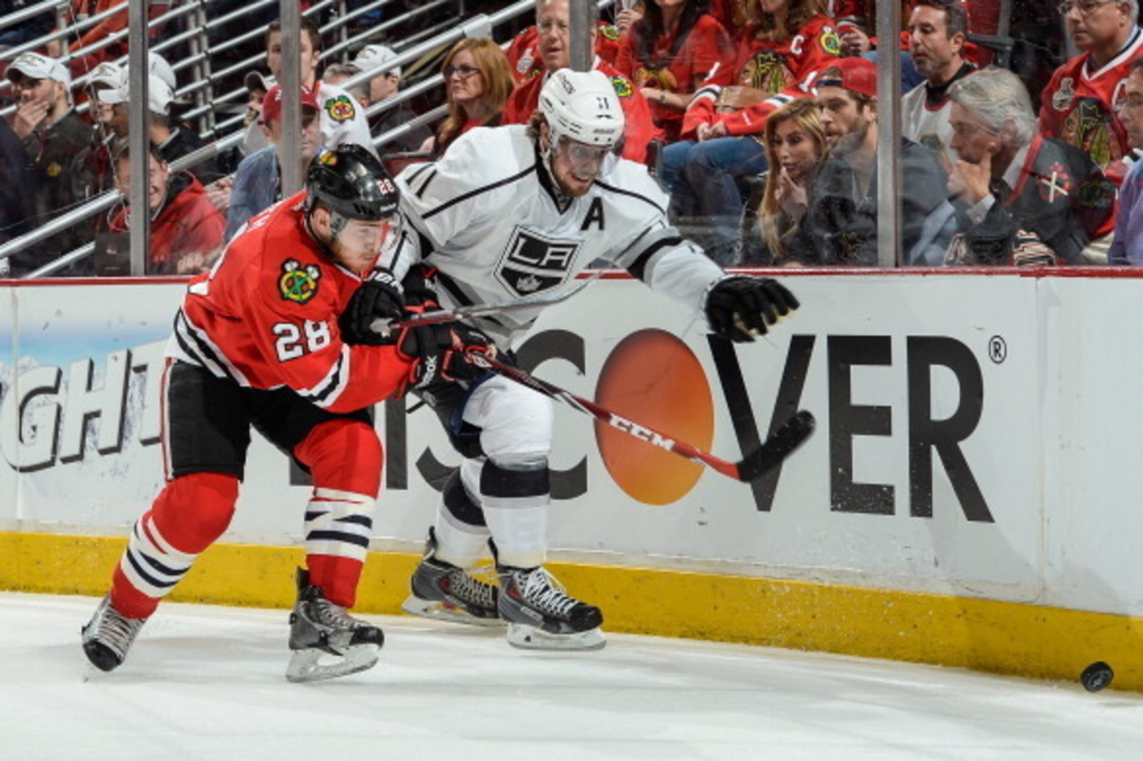 CHICAGO, IL - MAY 21: Ben Smith #28 of the Chicago Blackhawks and Anze Kopitar #11 of the Los Angeles Kings chase the puck in Game Two of the Western Conference Final during the 2014 NHL Stanley Cup Playoffs at the United Center on May 21, 2014 in Chicago