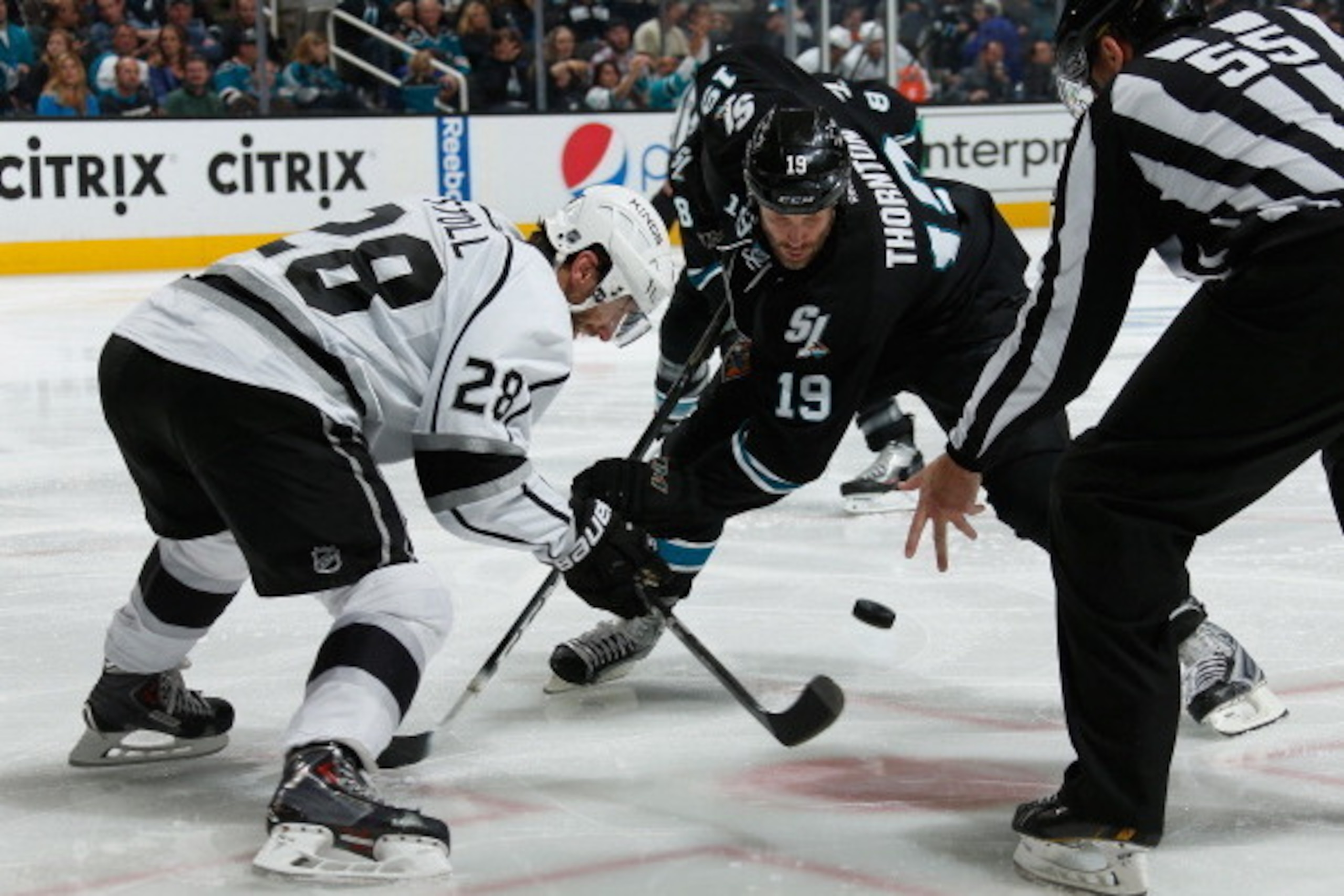 SAN JOSE, CA - APRIL 26: Joe Thornton #19 of the San Jose Sharks takes a face-off against Jarret Stoll #28 of the Los Angeles Kings in Game Five of the First Round of the 2014 Stanley Cup Playoffs at SAP Center on April 26, 2014 in San Jose, California. (