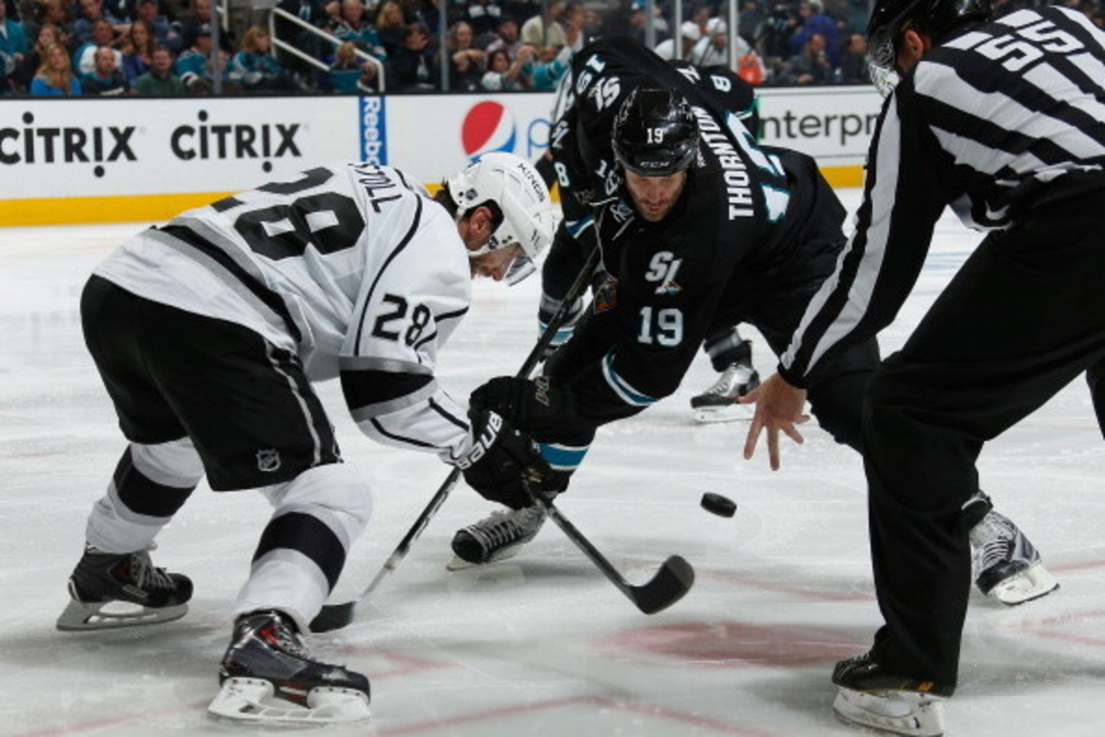 SAN JOSE, CA - APRIL 26: Joe Thornton #19 of the San Jose Sharks takes a face-off against Jarret Stoll #28 of the Los Angeles Kings in Game Five of the First Round of the 2014 Stanley Cup Playoffs at SAP Center on April 26, 2014 in San Jose, California. (