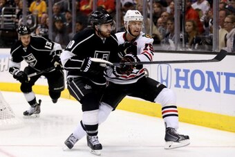 LOS ANGELES, CA - MAY 26:  Mike Richards #10 of the Los Angeles Kings and Jonathan Toews #19 of the Chicago Blackhawks go after the puck in the first period in Game Four of the Western Conference Final during the 2014 Stanley Cup Playoffs at Staples Cente