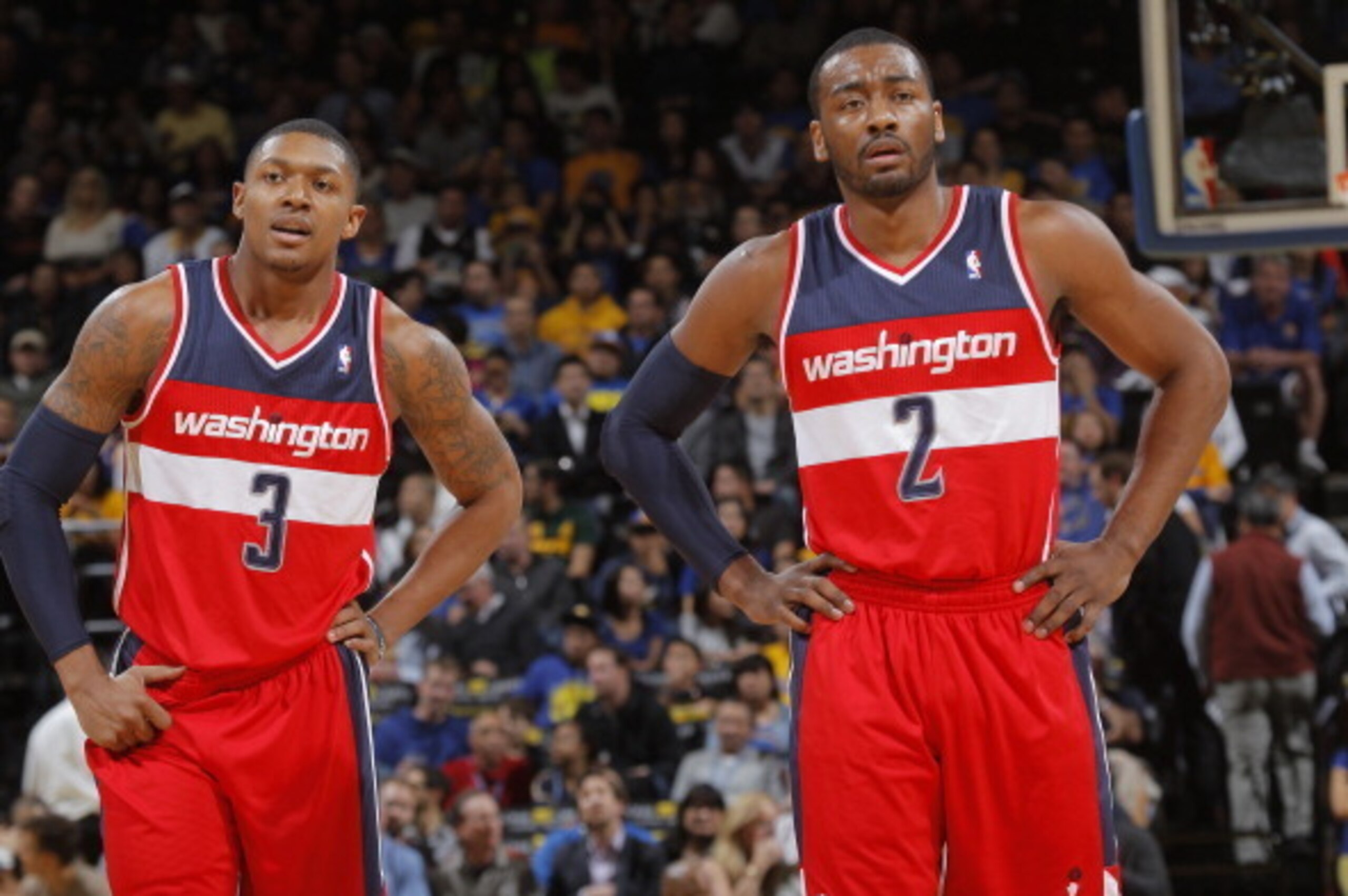 OAKLAND, CA - JANUARY 28: Bradley Beal #3 chats with teammate John Wall #2 of the Washington Wizards while facing the Golden State Warriors on January 28, 2014 at Oracle Arena in Oakland, California. NOTE TO USER: User expressly acknowledges and agrees th