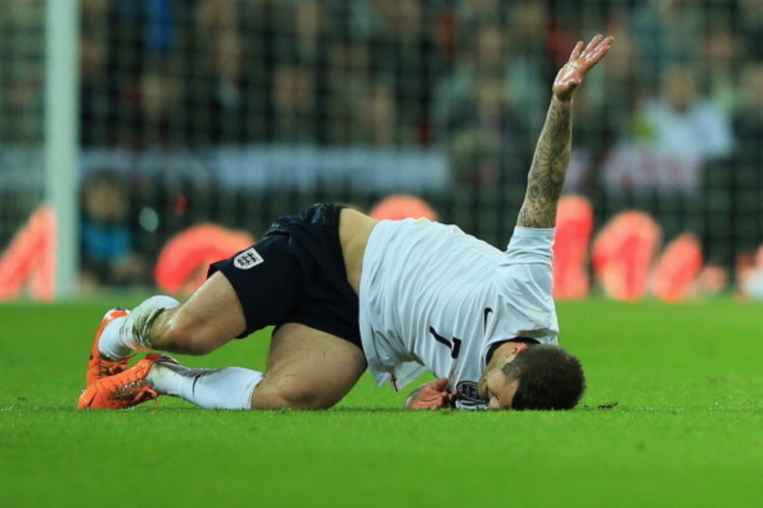 LONDON, ENGLAND - MARCH 05: Jack Wilshere of England grimaces as he goes to ground during the International Friendly match between England and Denmark at Wembley Stadium on March 5, 2014 in London, England.  (Photo by Richard Heathcote/Getty Images)