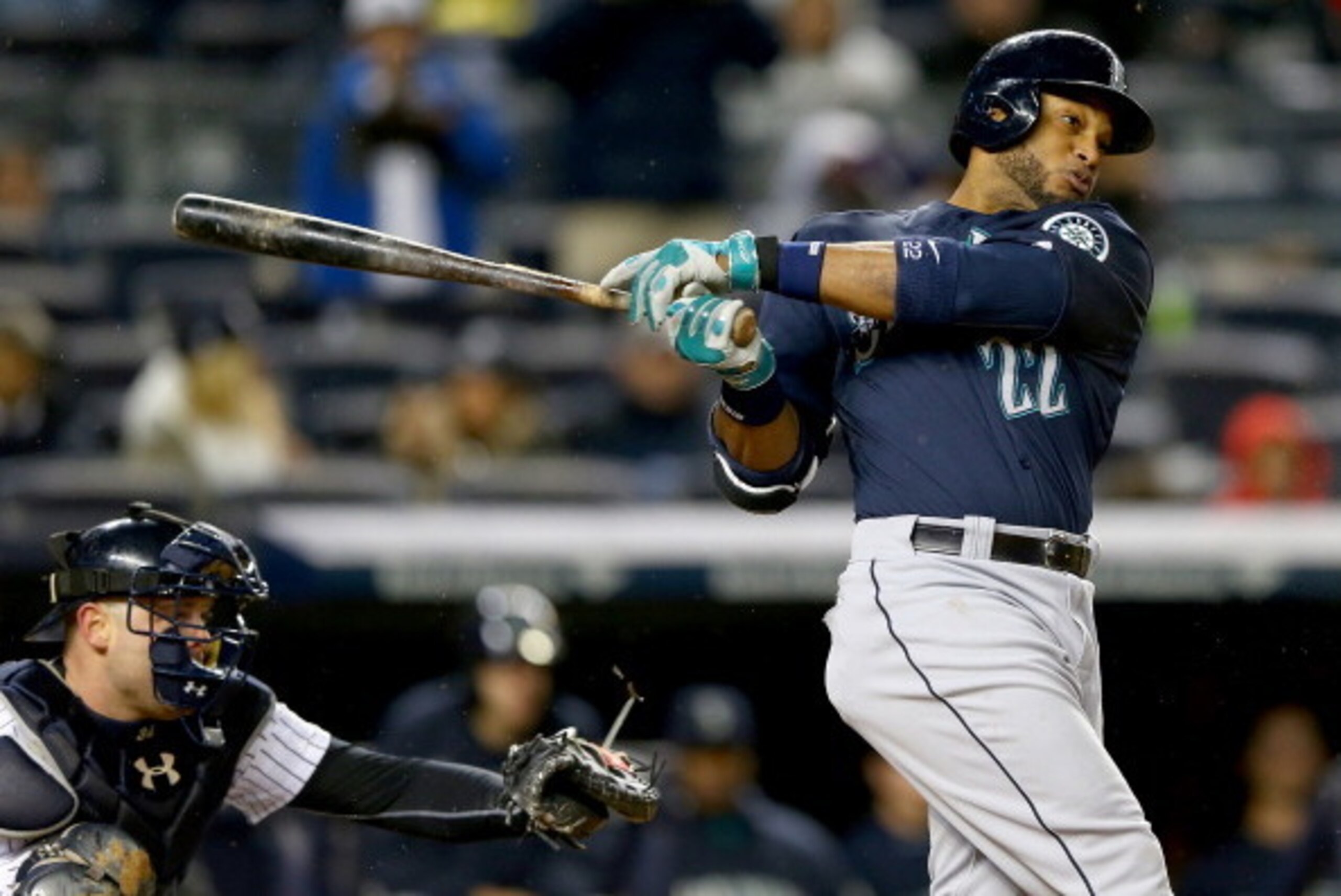 NEW YORK, NY - APRIL 29:  Robinson Cano #22 of the Seattle Mariners drives in a run with this ground out to first base as catcher Brian McCann #34 of the New York Yankees defends in the fifth inning on April 29, 2014 at Yankee Stadium in the Bronx borough