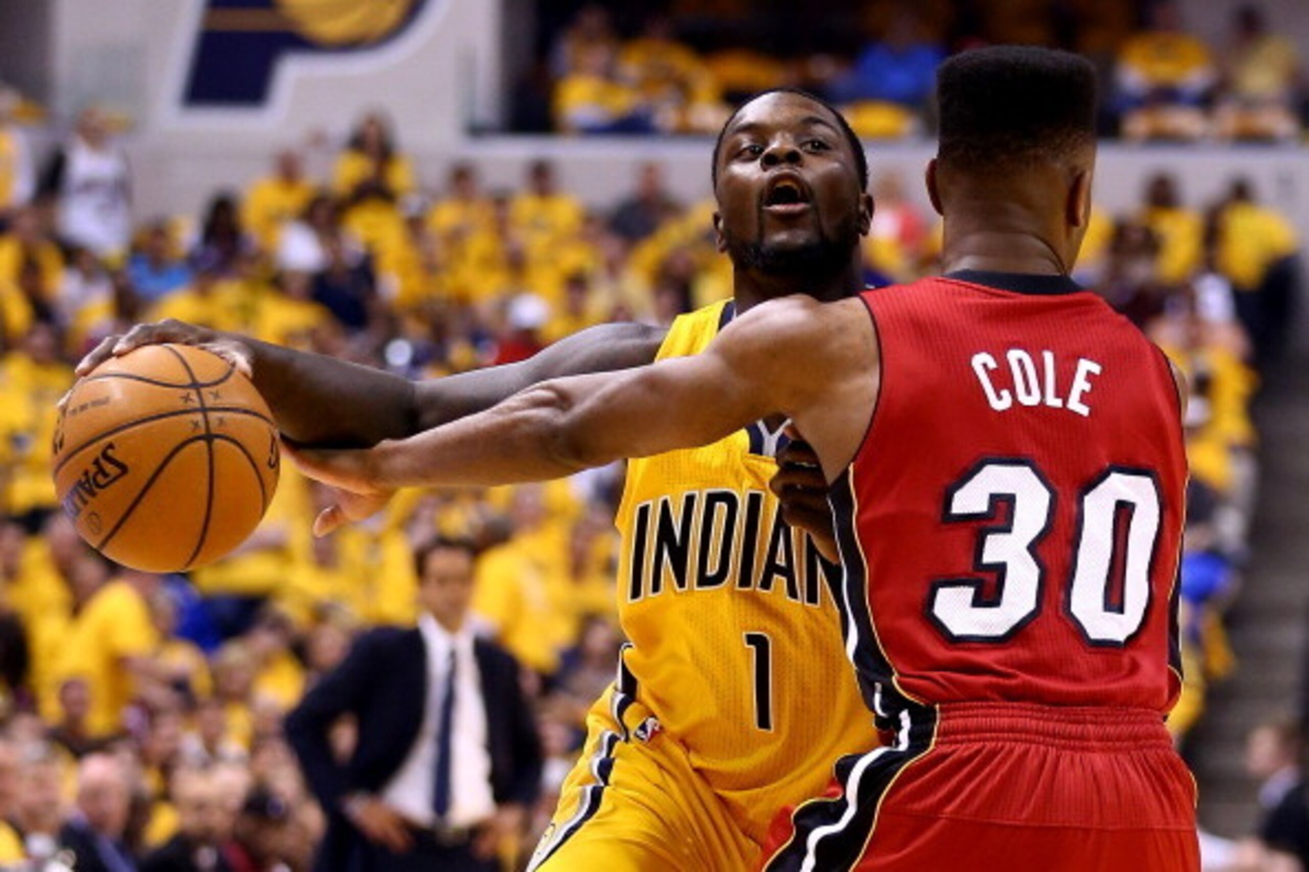 INDIANAPOLIS, IN - MAY 18:  Lance Stephenson #1 of the Indiana Pacers drives to the basket as Norris Cole #30 of the Miami Heat defends during Game One of the Eastern Conference Finals of the 2014 NBA Playoffs at Bankers Life Fieldhouse on May 18, 2014 in