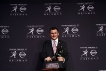 Dec 8, 2012; New York, NY, USA; Texas A&M Aggies quarterback Johnny Manziel poses for a photo with the Heisman Trophy during a press conference before the announcement of the 2012 Heisman Trophy winner at the Marriott Marquis in downtown New York City.  M
