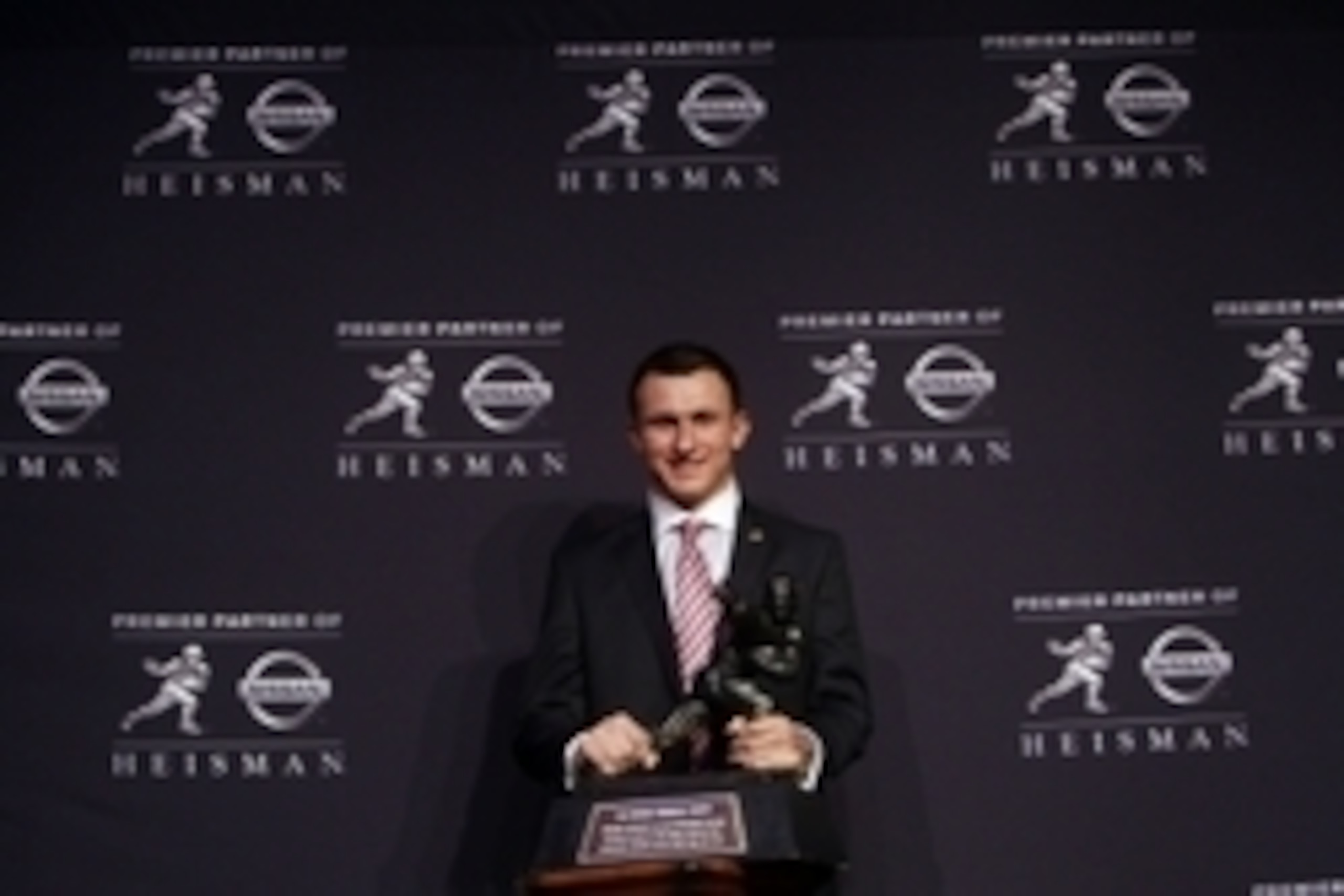Dec 8, 2012; New York, NY, USA; Texas A&M Aggies quarterback Johnny Manziel poses for a photo with the Heisman Trophy during a press conference before the announcement of the 2012 Heisman Trophy winner at the Marriott Marquis in downtown New York City.  M