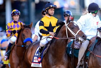 LOUISVILLE, KY - MAY 03:  Commanding Curve #17, ridden by Shaun Bridgmohan, takes part in the post parade prior the 140th running of the Kentucky Derby at Churchill Downs on May 3, 2014 in Louisville, Kentucky.  (Photo by Rob Carr/Getty Images)