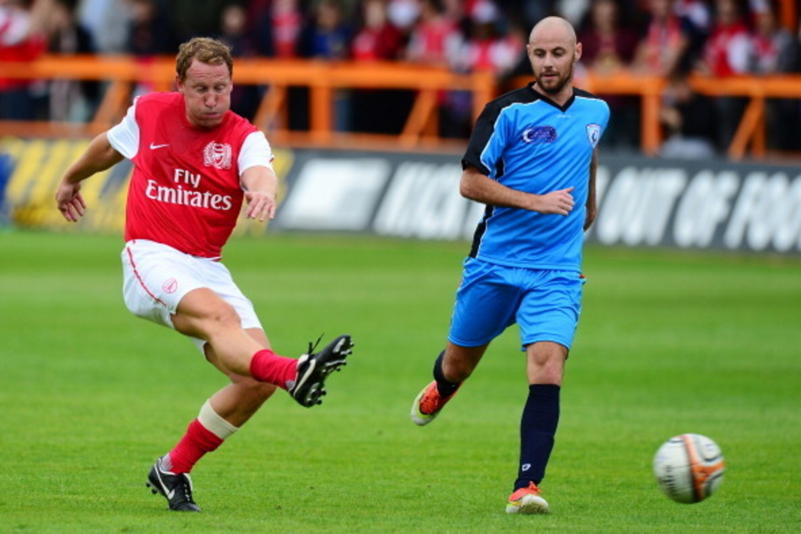 BARNET, ENGLAND - JUNE 23: Ray Parlour of Arsenal Legends XI (L) shoots at goal during the charity football match between Arsenal Legends XI and World Refugee Internally Displaced Persons (IDP) XI at Underhill Stadium on June 23, 2013 in Barnet, United Ki