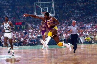 BOSTON, MA - 1985: Magic Johnson #32 of the Los Angeles Lakers passes against the Boston Celtics circa 1985 at the Boston Garden in Boston, Massachussetts. NOTE TO USER: User expressly acknowledges and agrees that, by downloading and or using this photogr