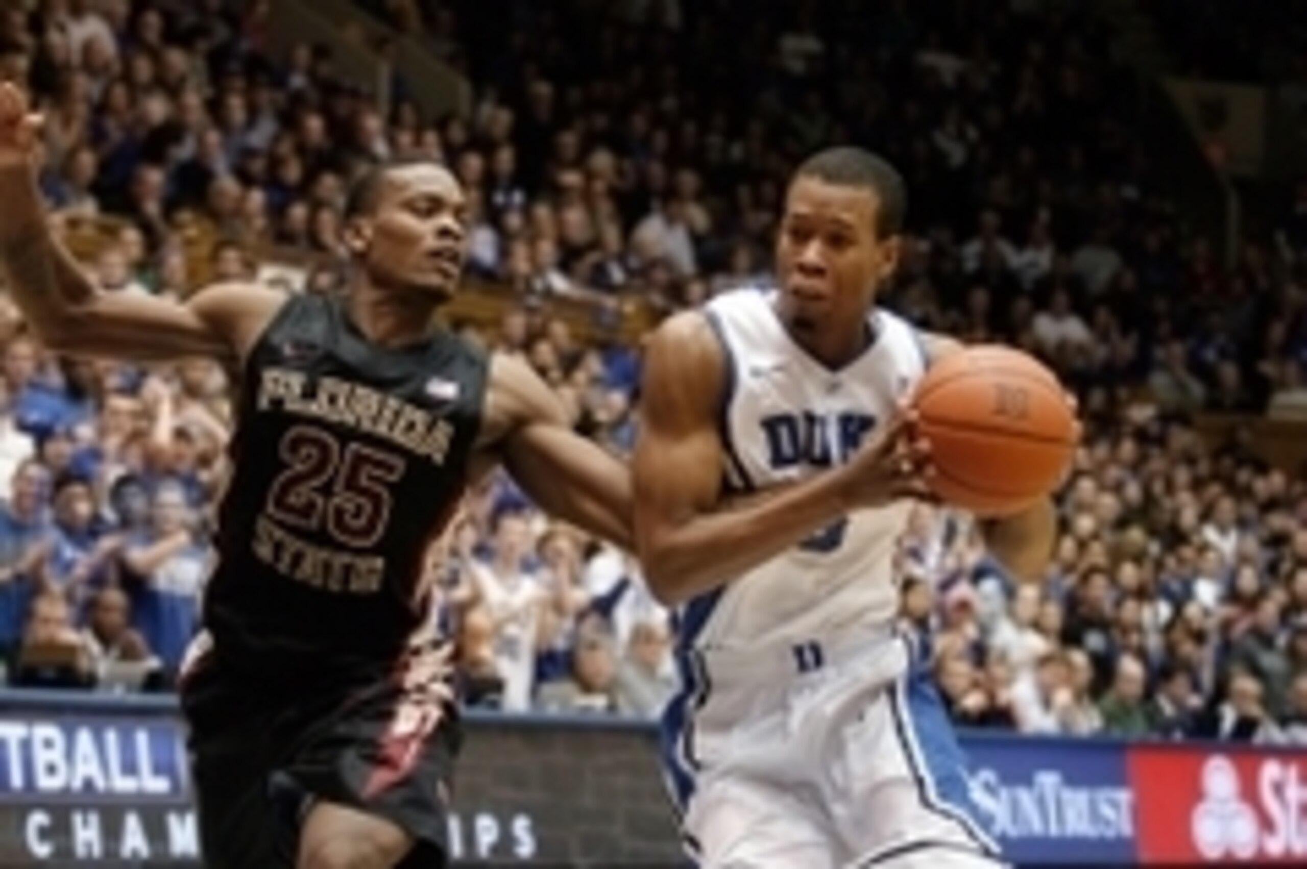 Jan 25, 2014; Durham, NC, USA; Duke Blue Devils forward Rodney Hood (5) drives against Florida State Seminoles guard Aaron Thomas (25) at Cameron Indoor Stadium. Mandatory Credit: Mark Dolejs-USA TODAY Sports