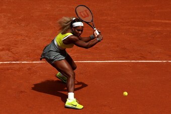 PARIS, FRANCE - MAY 28:  Serena Williams of the United States returns a shot during her women's singles match against Garbine Muguruza of Spain on day four of the French Open at Roland Garros on May 28, 2014 in Paris, France.  (Photo by Matthew Stockman/G
