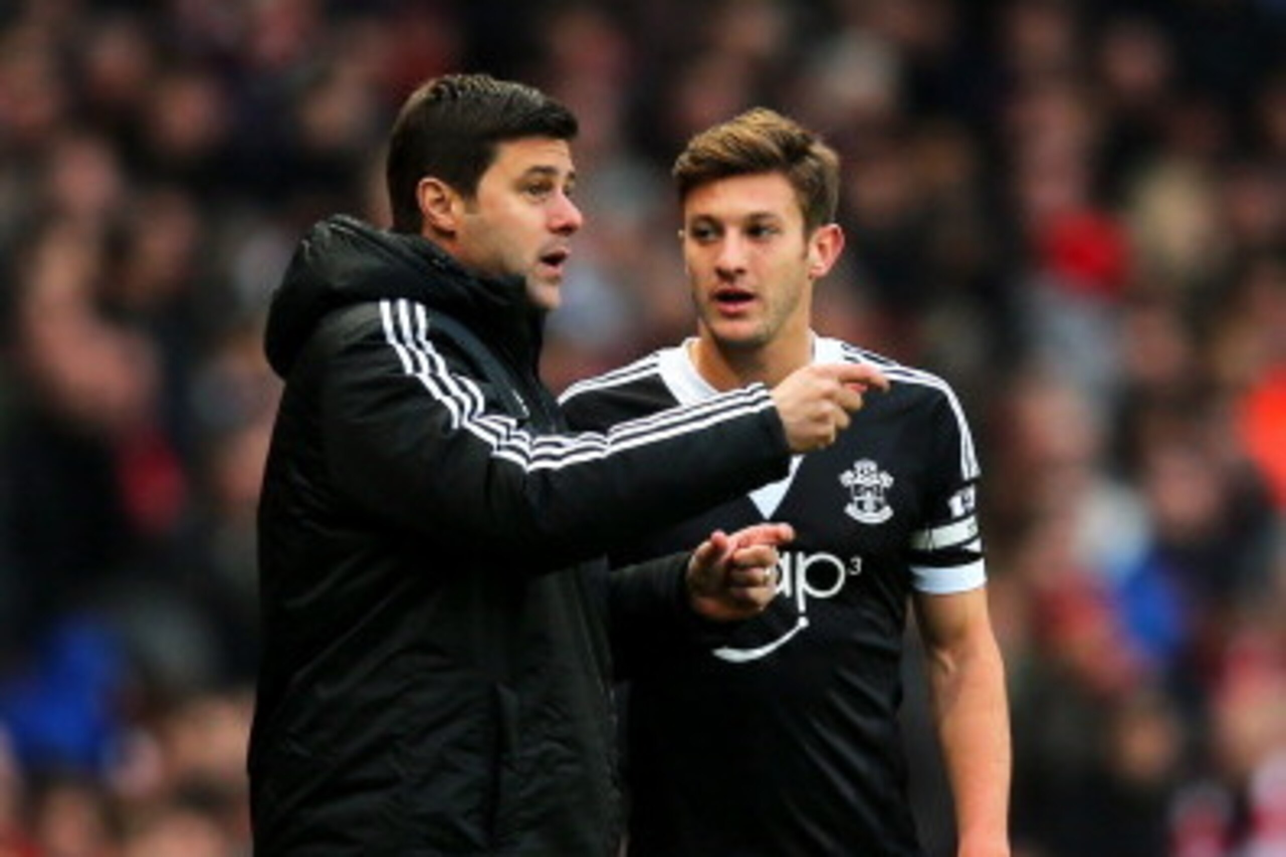 LONDON, ENGLAND - NOVEMBER 23:  Mauricio Pochettino, manager of Southampton gives instructions to Adam Lallana of Southampton during the Barclays Premier League match between Arsenal and Southampton at Emirates Stadium on November 23, 2013 in London, Engl