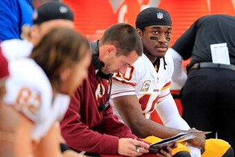 PHILADELPHIA, PA - NOVEMBER 17: Quarterback Robert Griffin III #10 of the Washington Redskins talks with offensive coordinator Kyle Shanahan (L) during the first half against the Philadelphia Eagles at Lincoln Financial Field on November 17, 2013 in Phila
