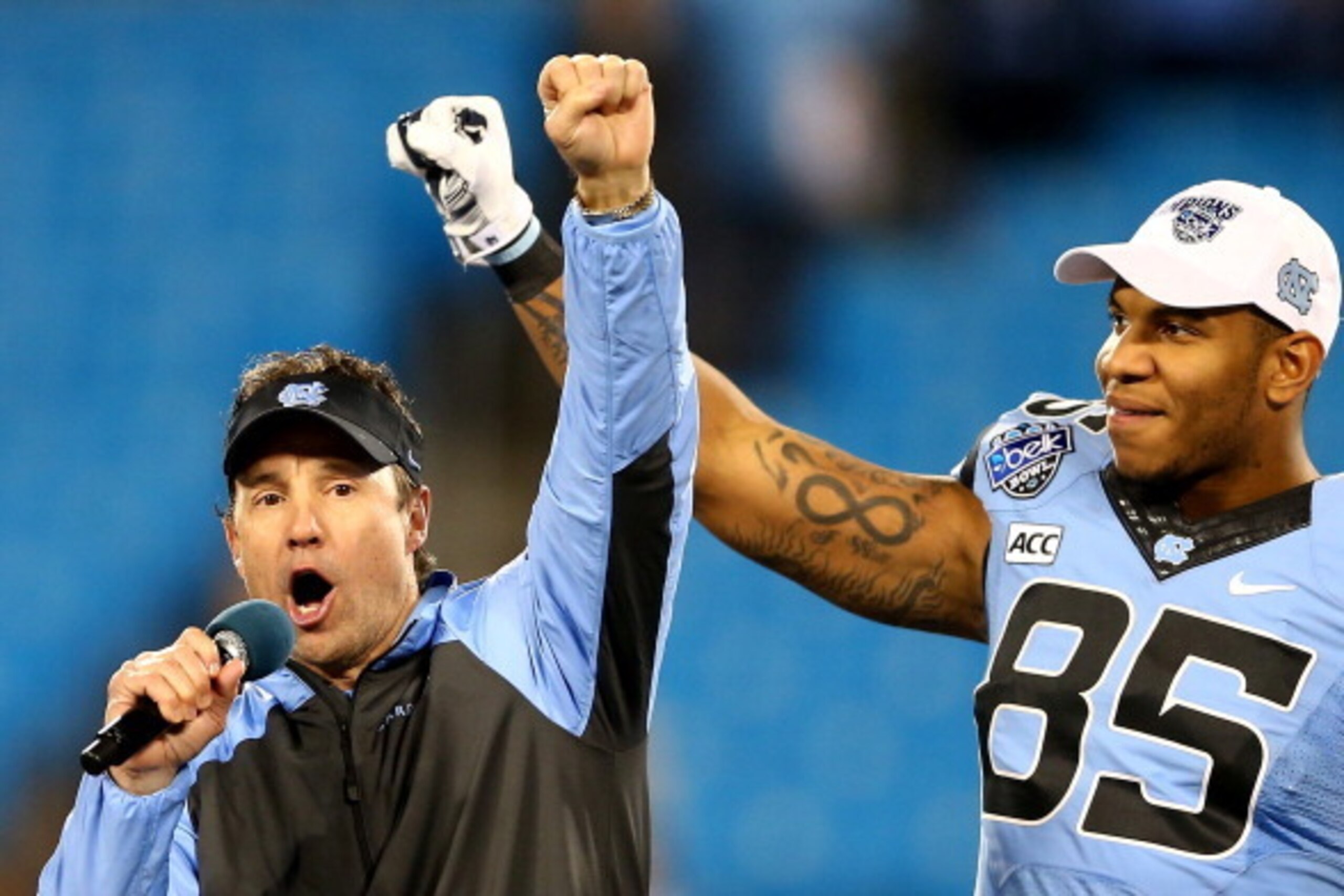 CHARLOTTE, NC - DECEMBER 28:  Head coach Larry Fedora of the North Carolina Tar Heels celebrates with Eric Ebron #85 after defeating the Cincinnati Bearcats 39-17 at Bank of America Stadium on December 28, 2013 in Charlotte, North Carolina.  (Photo by Str