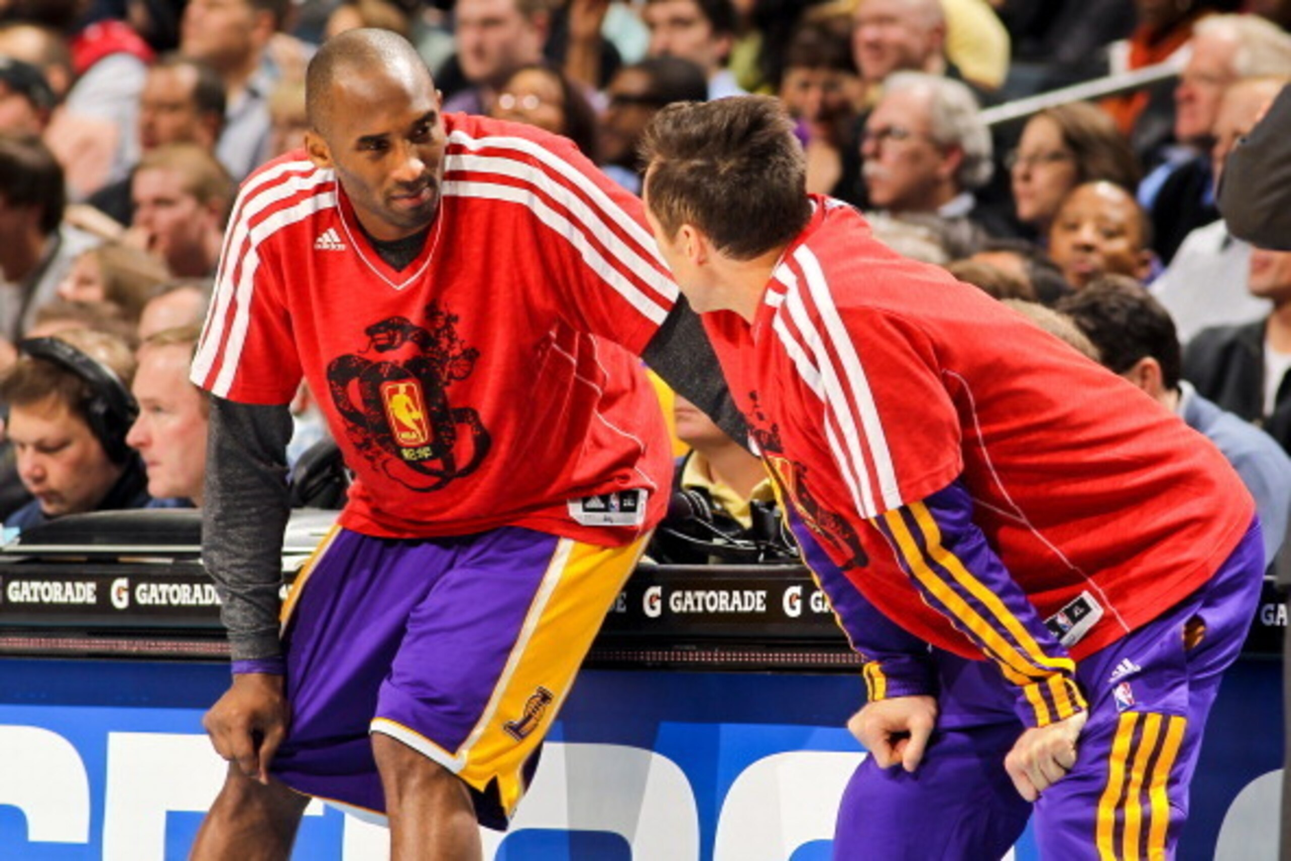 CHARLOTTE, NC - FEBRUARY 8: Kobe Bryant #24 and Steve Nash #10 of the Los Angeles Lakers, wearing shirts in honor of Chinese New Year, wait to check into a game against the Charlotte Bobcats at Time Warner Cable Arena on February 8, 2013 in Charlotte, Nor CHARLOTTE, NC - FEBRUARY 8: Kobe Bryant #24 and Steve Nash #10 of the Los Angeles Lakers, wearing shirts in honor of Chinese New Year, wait to check into a game against the Charlotte Bobcats at Time Warner Cable Arena on February 8, 2013 in Charlotte, Nor