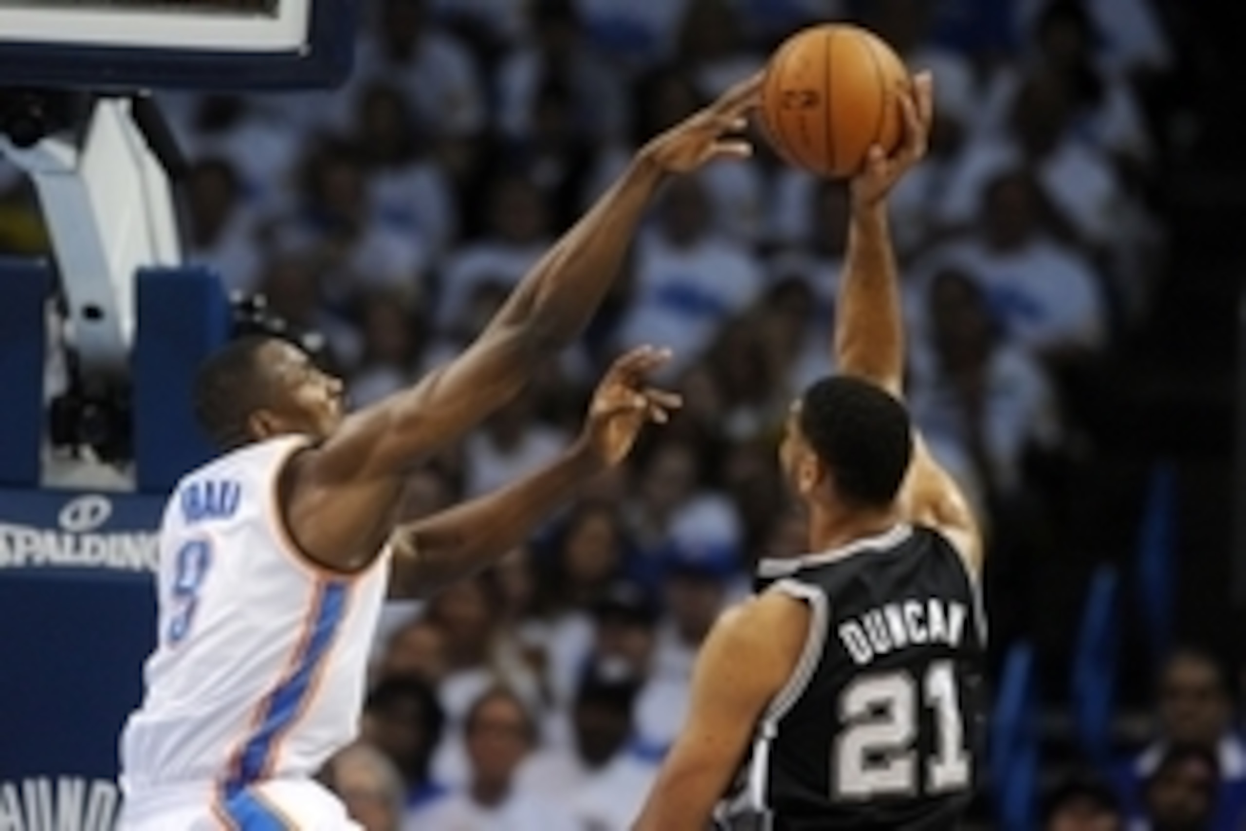 May 27, 2014; Oklahoma City, OK, USA; Oklahoma City Thunder forward Serge Ibaka (9) blocks a shot attempt by San Antonio Spurs forward Tim Duncan (21) during the second quarter in game four of the Western Conference Finals of the 2014 NBA Playoffs at Ches