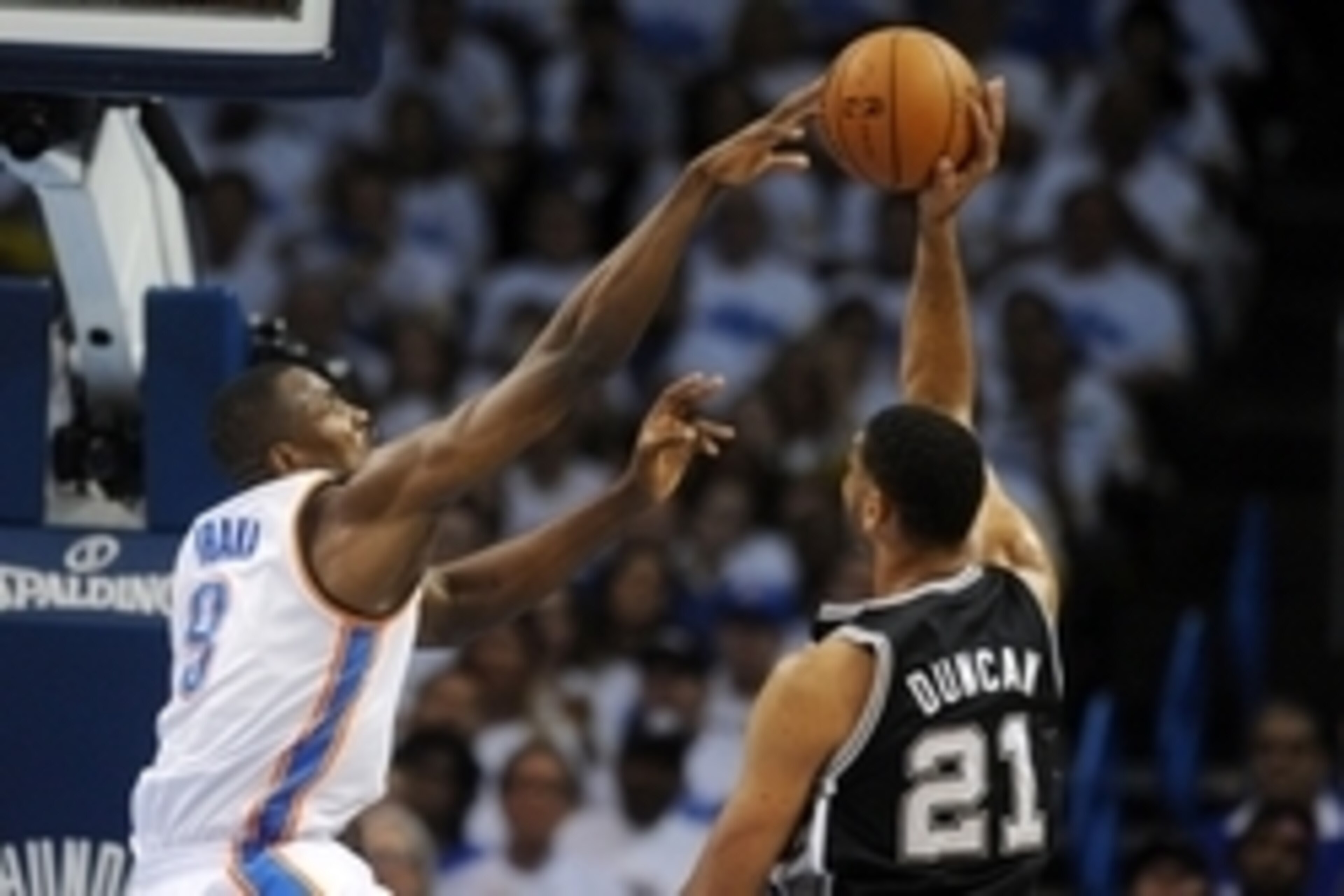 May 27, 2014; Oklahoma City, OK, USA; Oklahoma City Thunder forward Serge Ibaka (9) blocks a shot attempt by San Antonio Spurs forward Tim Duncan (21) during the second quarter in game four of the Western Conference Finals of the 2014 NBA Playoffs at Ches