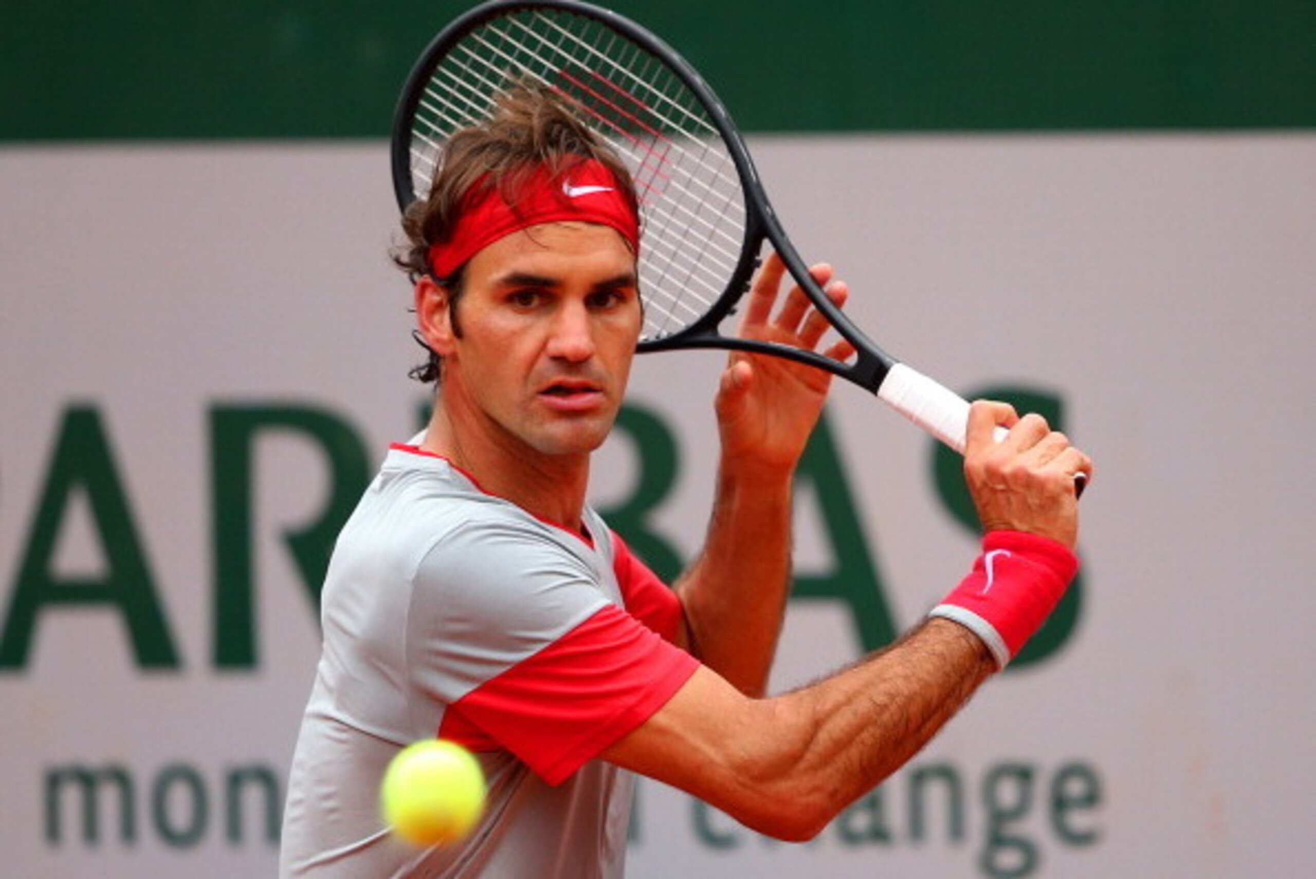PARIS, FRANCE - MAY 28:  Roger Federer of Switzerland returns a shot during his men';s singles match against Diego Sebastian Schwartzman of Argentina on day four of the French Open at Roland Garros on May 28, 2014 in Paris, France.  (Photo by Clive Brunsk