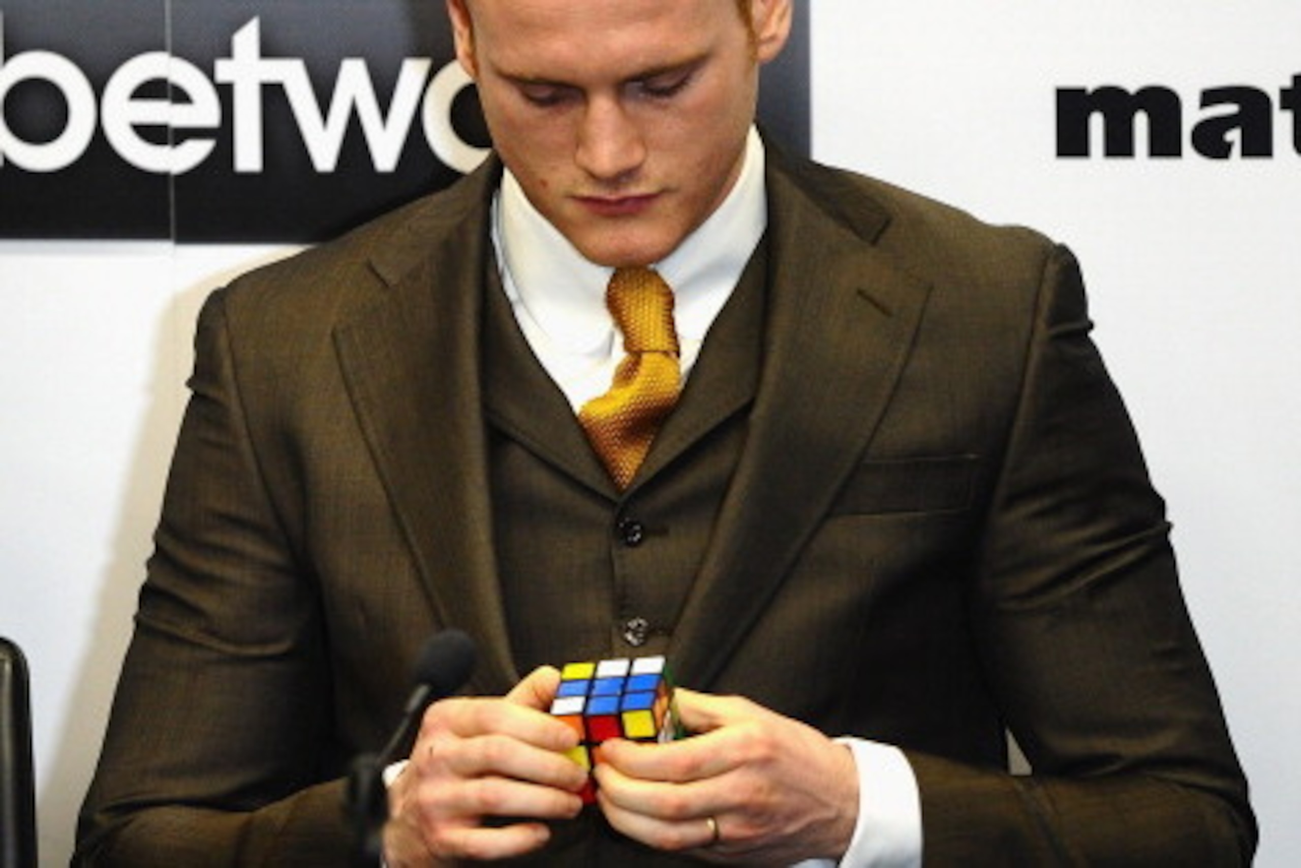 LONDON, ENGLAND - MARCH 10: Boxer George Groves plays with a Rubik's Cube as Carl Froch speaks during a Press Conference at Wembley Stadium on March 10, 2014 in London, England.  (Photo by Laurence Griffiths/Getty Images)
