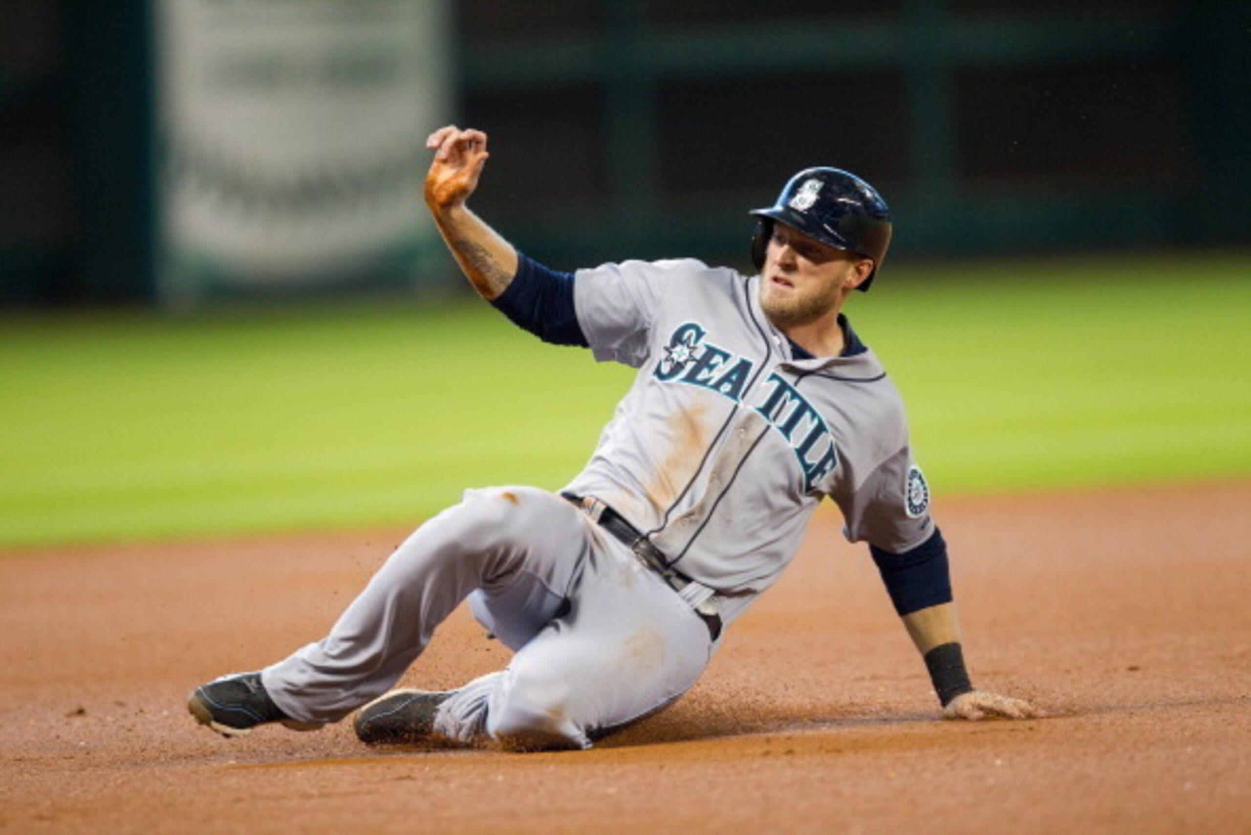 HOUSTON, TX - MAY 04: Michael Saunders #55 of the Seattle Mariners slides into third base in the first inning against the Houston Astros at Minute Maid Park on May 4, 2014 in Houston, Texas. (Photo by Bob Levey/Getty Images)