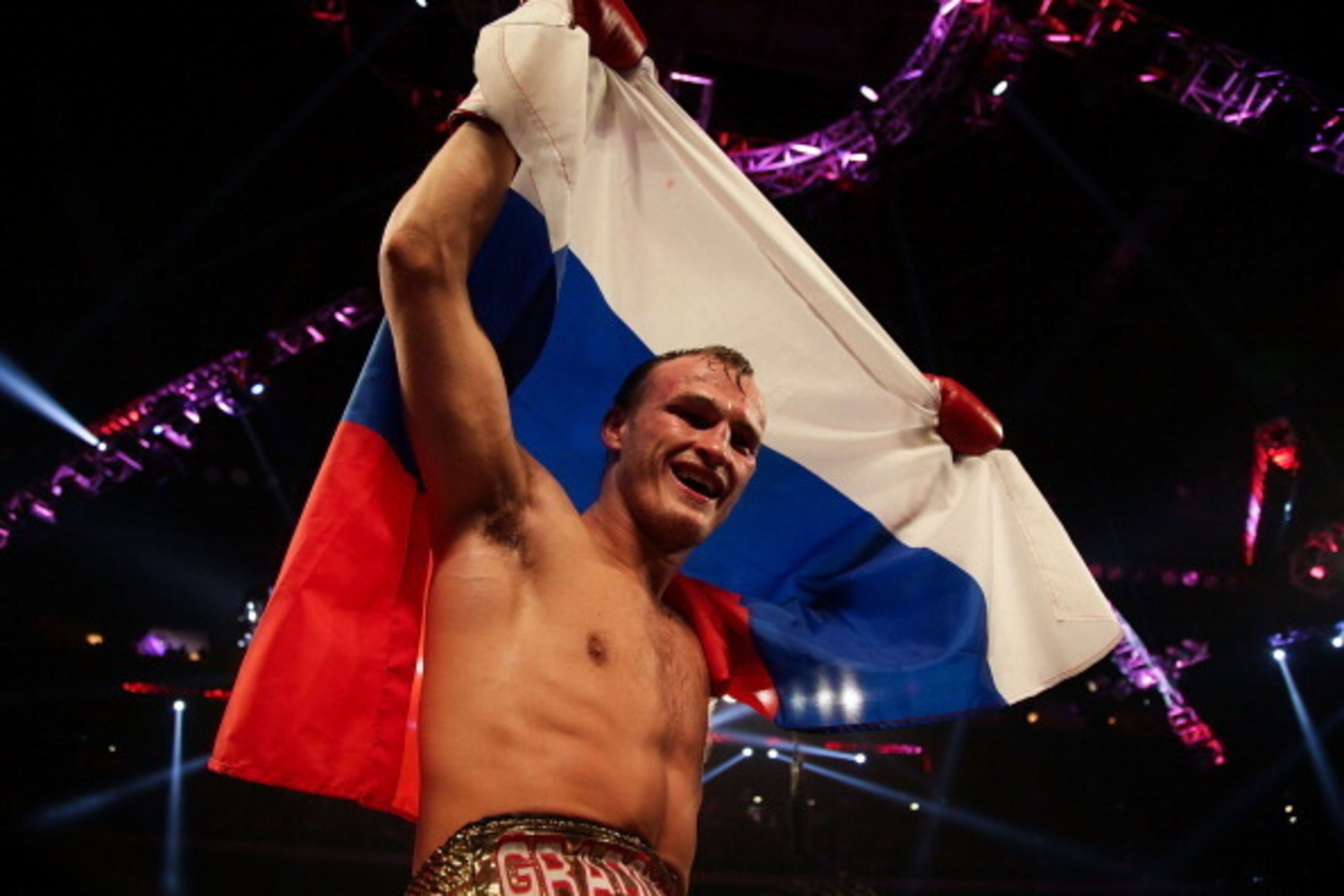 MACAU - NOVEMBER 24:  Evgeny Gradovich of Russia celebrates defeating Billy Dib of Australia during their 'Clash in Cotai' IBF Featherweight title bout on November 24, 2013 in Macau.  (Photo by Nicky Loh/Getty Images)