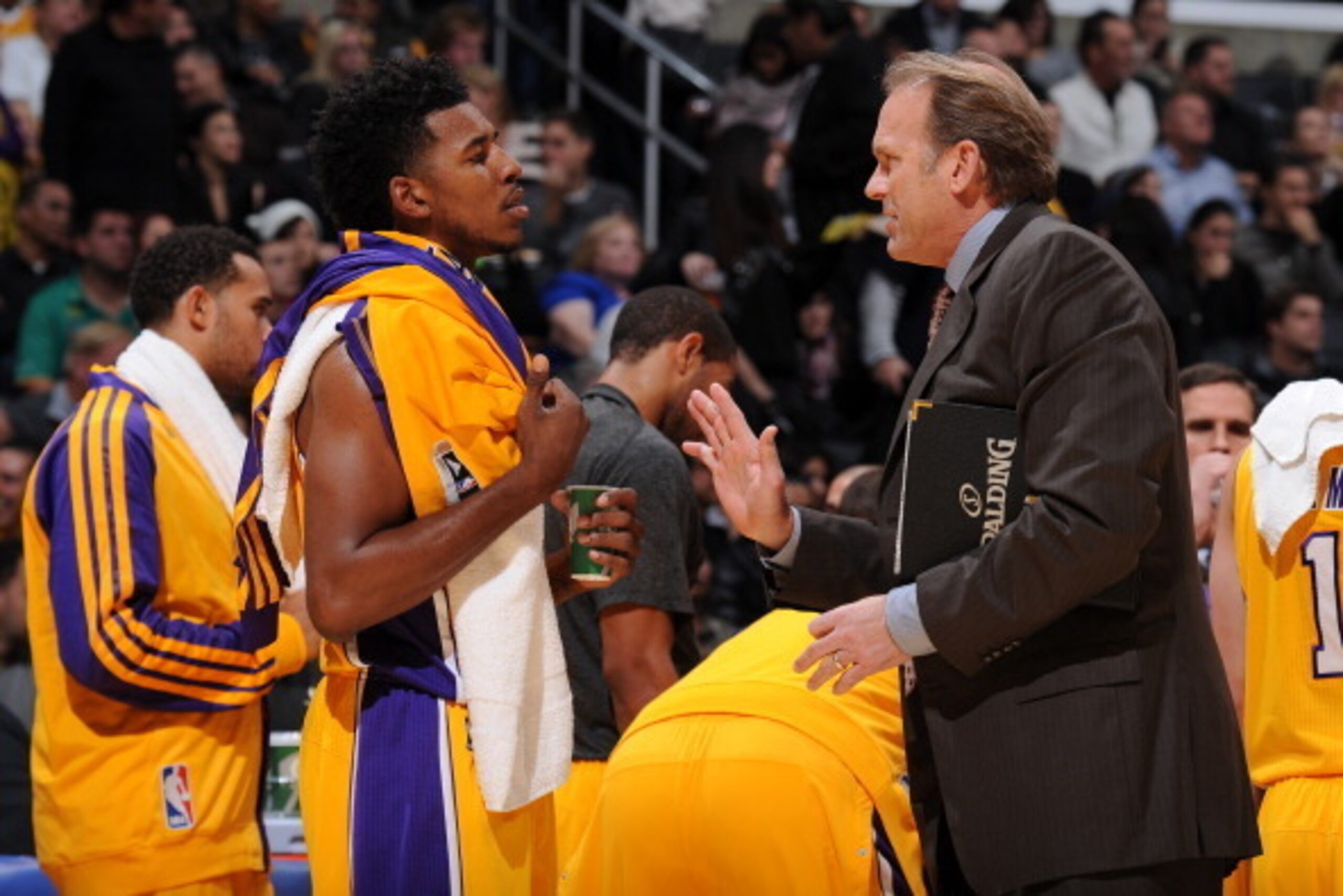 LOS ANGELES, CA - NOVEMBER 22: Kurt Rambis and Nick Young #0 of the Los Angeles Lakers converse during a game against the Golden State Warriors on November 22, 2013 at STAPLES Center in Los Angeles, California. NOTE TO USER: User expressly acknowledges an