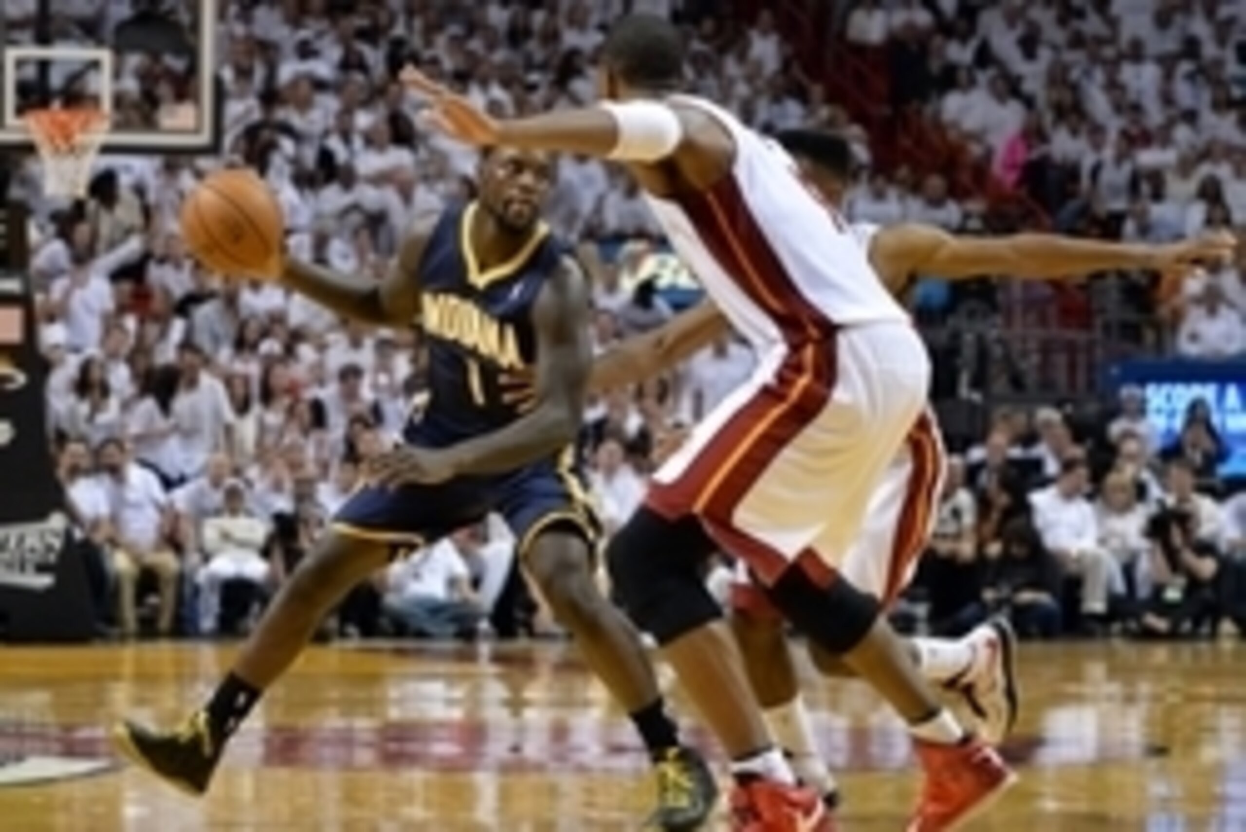 May 26, 2014; Miami, FL, USA; Indiana Pacers guard Lance Stephenson (1) moves the ball around guarded by Miami Heat center Chris Bosh (1) and guard Norris Cole (30) in game four of the Eastern Conference Finals of the 2014 NBA Playoffs at American Airline