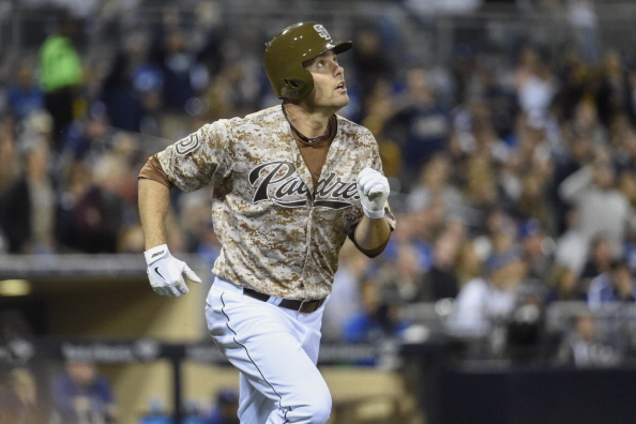 SAN DIEGO, CA - MARCH 30:  Seth Smith #12 of the San Diego Padres watches the flight of his solo home run hit during the eighth inning of a baseball game against the Los Angeles Dodgers on Opening Night at Petco Park on March 30, 2014 in San Diego, Califo