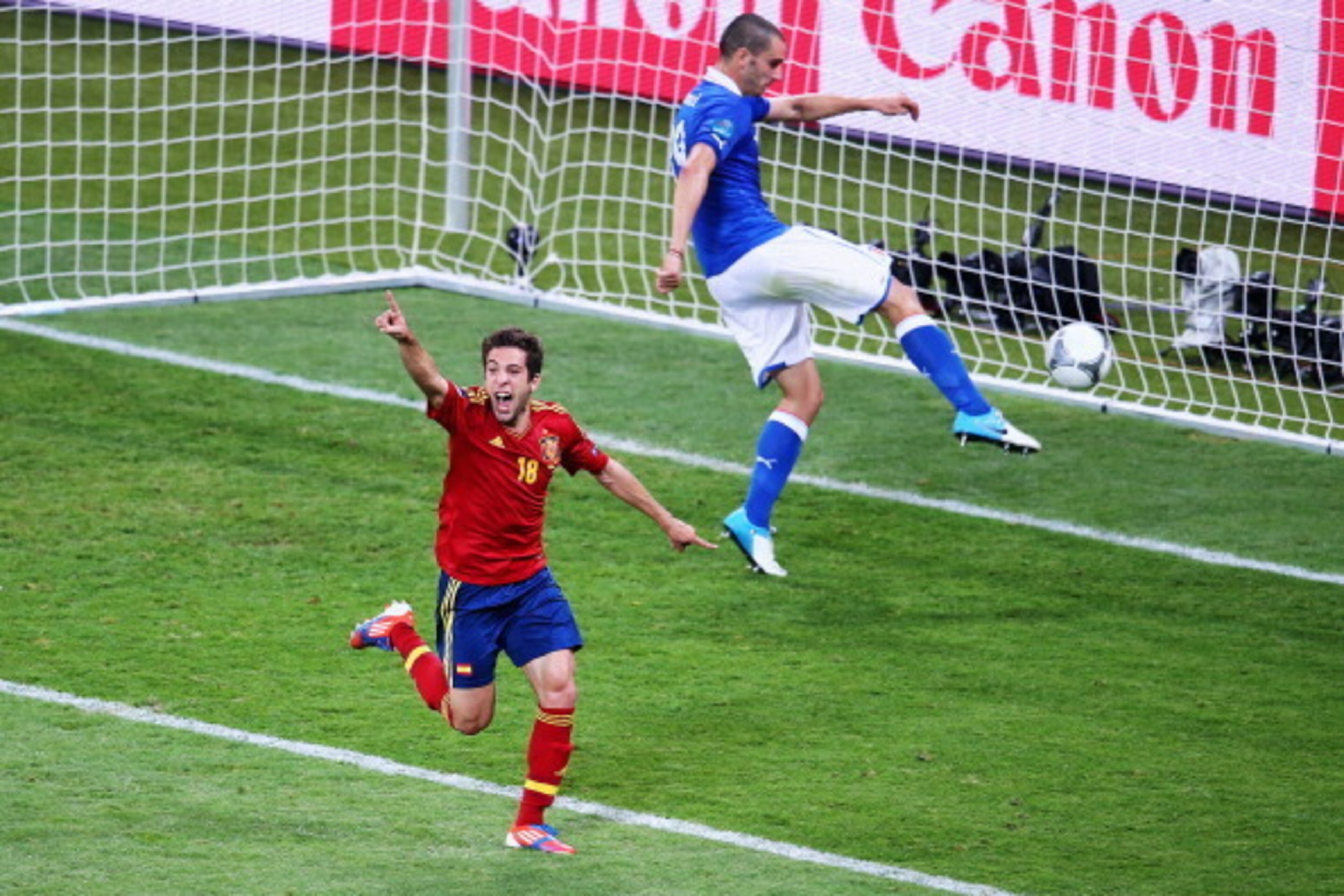 KIEV, UKRAINE - JULY 01:  Jordi Alba (L) of Spain celebrates after scoring his team's second goal as Leonardo Bonucci of Italy kicks the ball in frustration during the UEFA EURO 2012 final match between Spain and Italy at the Olympic Stadium on July 1, 20