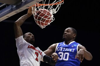 INDIANAPOLIS, IN - MARCH 28:  Russ Smith #2 of the Louisville Cardinals dunks the ball over Julius Randle #30 of the Kentucky Wildcats during the regional semifinal of the 2014 NCAA Men's Basketball Tournament at Lucas Oil Stadium on March 28, 2014 in Ind