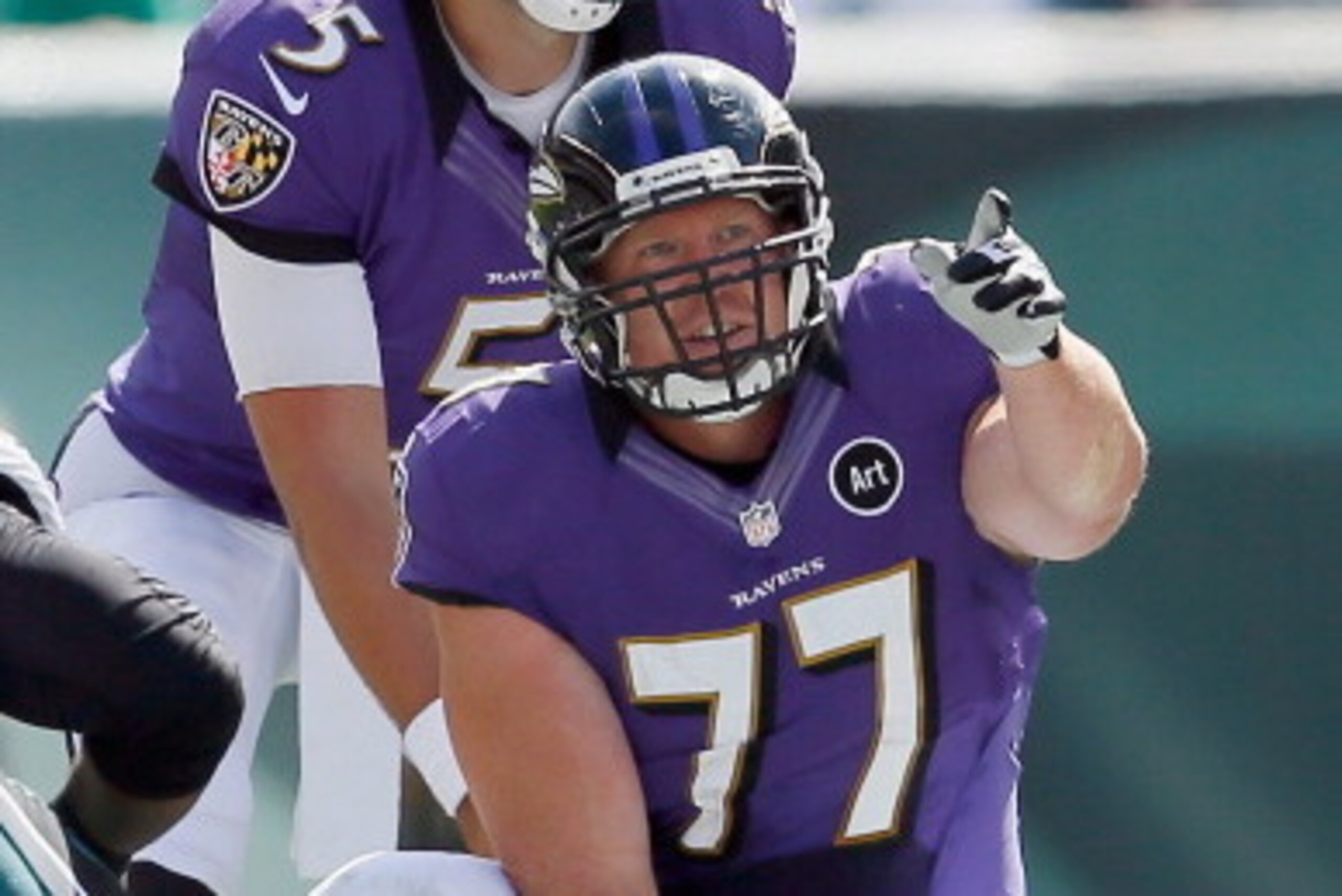 PHILADELPHIA, PA - SEPTEMBER 16: Center Matt Birk #77 of the Baltimore Ravens motions from the line of scrimmage as quarterback Joe Flacco #5 calls the signal against the Philadelphia Eagles at Lincoln Financial Field on September 16, 2012 in Philadelphia