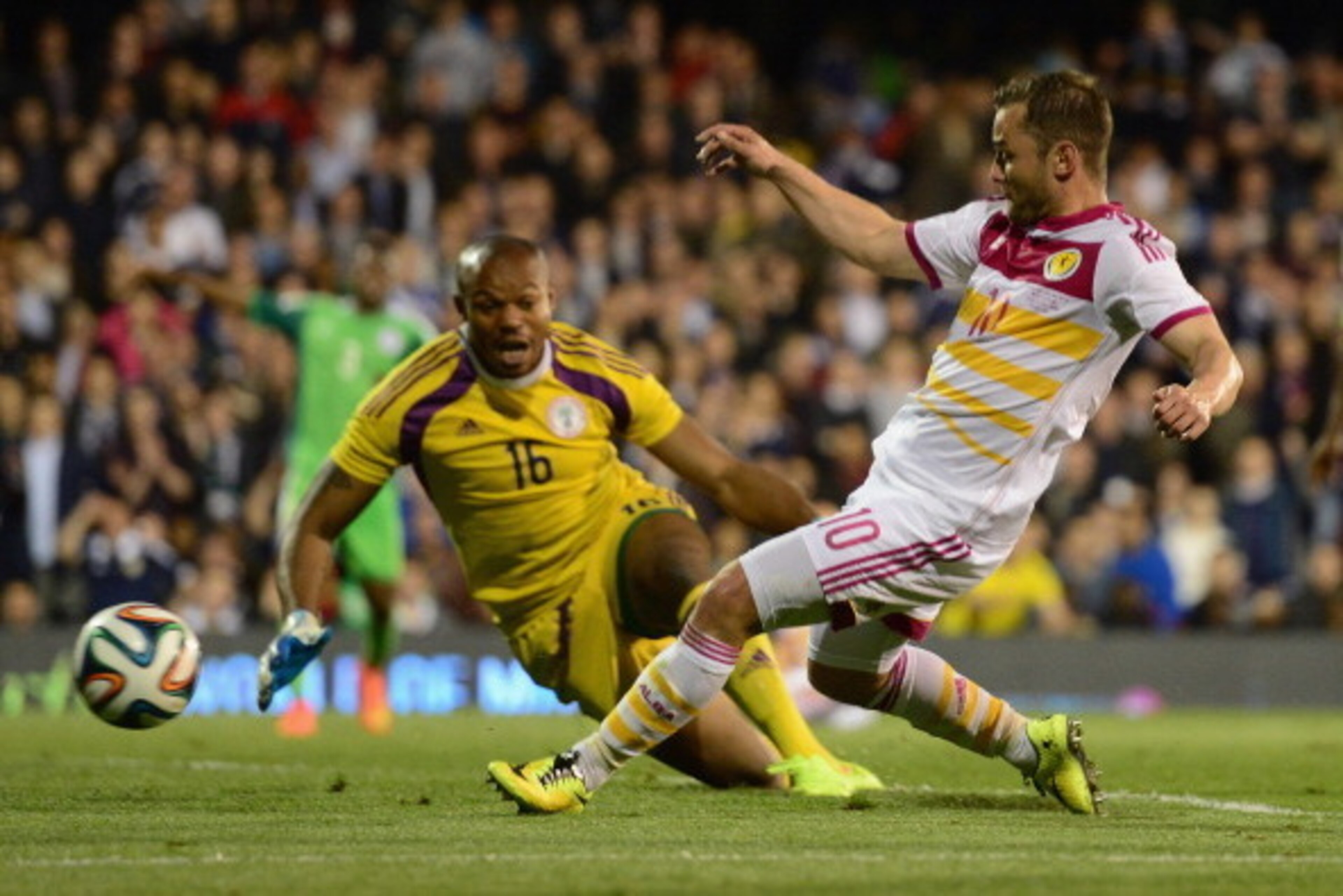 LONDON, ENGLAND - MAY 28:  Shaun Maloney of Scotland beats the dive of Austine Ejide of Nigeria during the International Friendly match between Nigeria and Scotland at Craven Cottage on May 28, 2014 in London, United Kingdom.  (Photo by Jamie McDonald/Get
