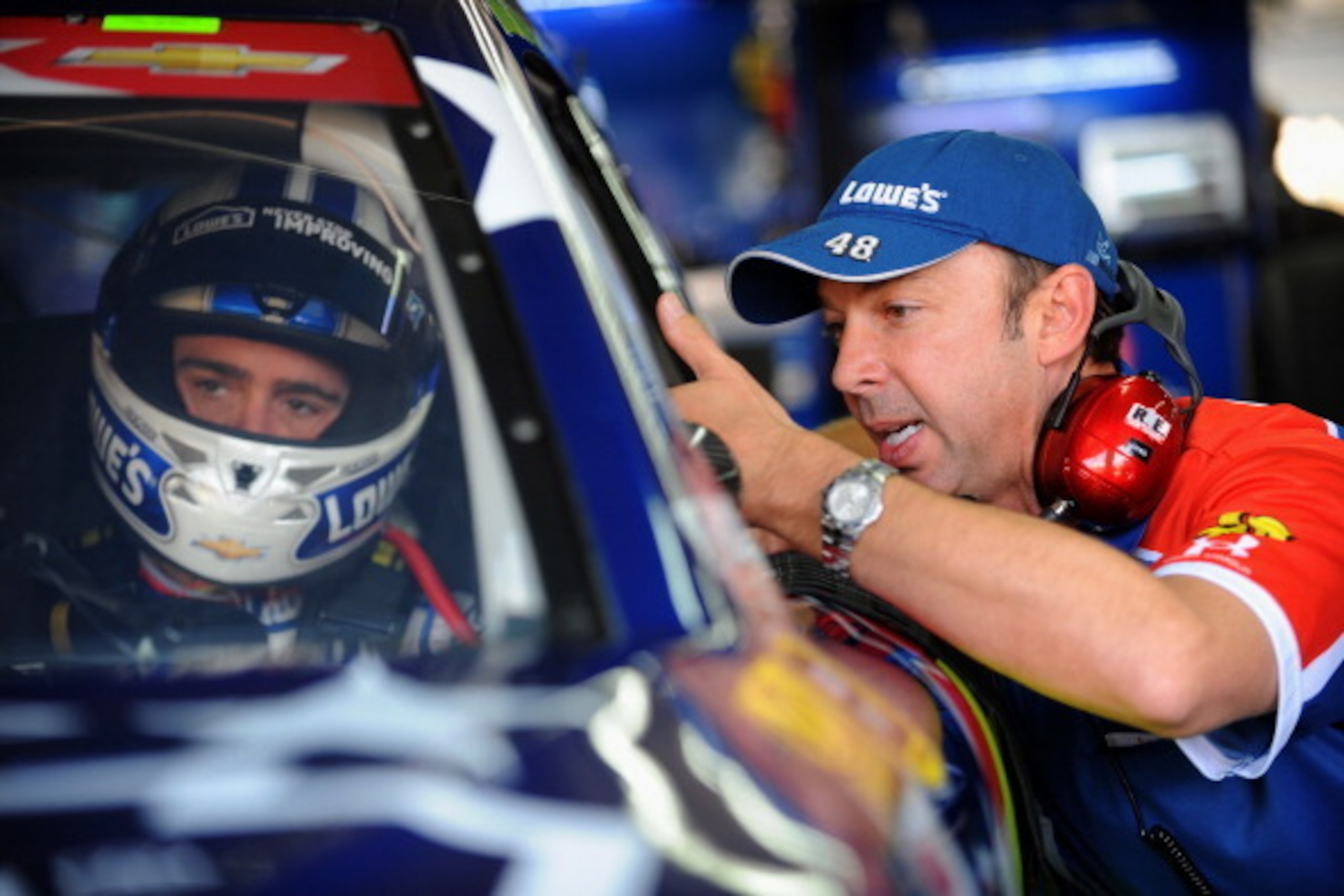CHARLOTTE, NC - MAY 24: Jimmie Johnson, driver of the #48 Lowe's Patriotic Chevrolet, talks to his crew chief, Chad Knaus, during practice for the NASCAR Sprint Cup Series Coca-Cola 600 at Charlotte Motor Speedway on May 24, 2014 in Charlotte, North Carol