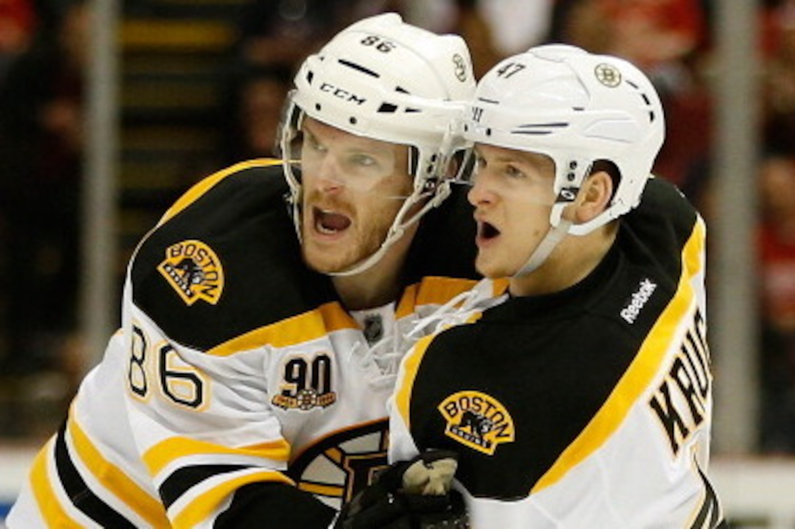 DETROIT, MI - APRIL 24:  Torey Krug #47 of the Boston Bruins celebrates his second-period goal with Kevan Miller #86 during action against the Detroit Red Wings in Game Four of the First Round of the 2014 NHL Stanley Cup Playoffs at Joe Louis Arena on Apr