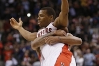 Mar 23, 2014; Toronto, Ontario, CAN; Toronto Raptors guard Kyle Lowry (left) gets hugged by guard DeMar DeRozan (right) after a win over the Atlanta Hawks at the Air Canada Centre. Toronto defeated Atlanta 96-86. Mandatory Credit: John E. Sokolowski-USA T