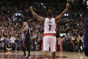 Mar 23, 2014; Toronto, Ontario, CAN; Toronto Raptors guard Kyle Lowry (7) celebrates a win as Atlanta Hawks center Pero Antic (6) walks off the court at the Air Canada Centre. Toronto defeated Atlanta 96-86. Mandatory Credit: John E. Sokolowski-USA TODAY 