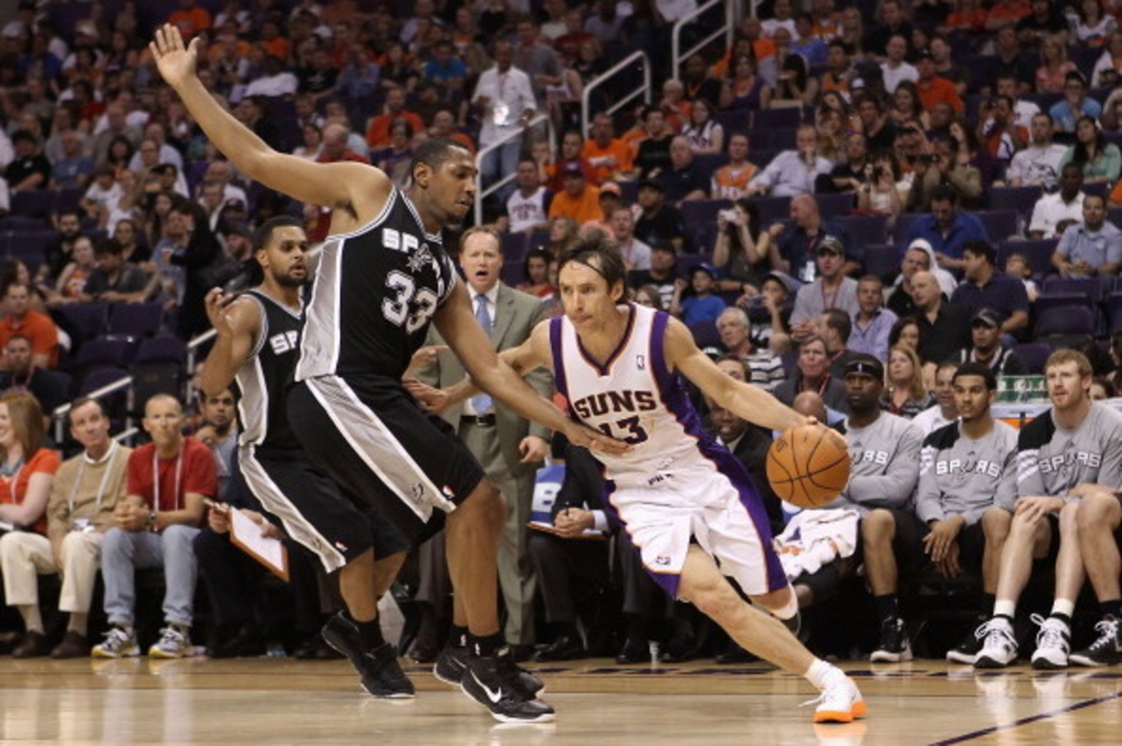 PHOENIX, AZ - APRIL 25:  Steve Nash #13 of the Phoenix Suns drives the ball past Boris Diaw #33 of the San Antonio Spurs during the NBA game at US Airways Center on April 25, 2012 in Phoenix, Arizona.  The Spurs defeated the Suns 110-106.  NOTE TO USER: U