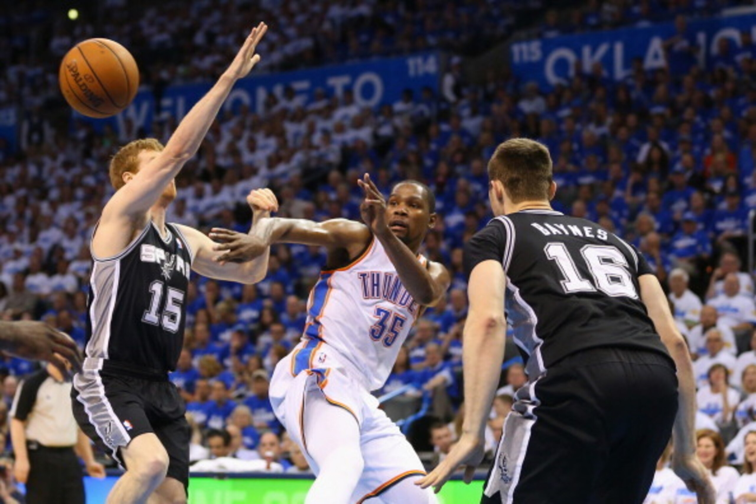 OKLAHOMA CITY, OK - MAY 27: Kevin Durant #35 of the Oklahoma City Thunder passes against Matt Bonner #15 and Aron Baynes #16 of the San Antonio Spurs in the third quarter during Game Four of the Western Conference Finals of the 2014 NBA Playoffs at Chesap OKLAHOMA CITY, OK - MAY 27: Kevin Durant #35 of the Oklahoma City Thunder passes against Matt Bonner #15 and Aron Baynes #16 of the San Antonio Spurs in the third quarter during Game Four of the Western Conference Finals of the 2014 NBA Playoffs at Chesap