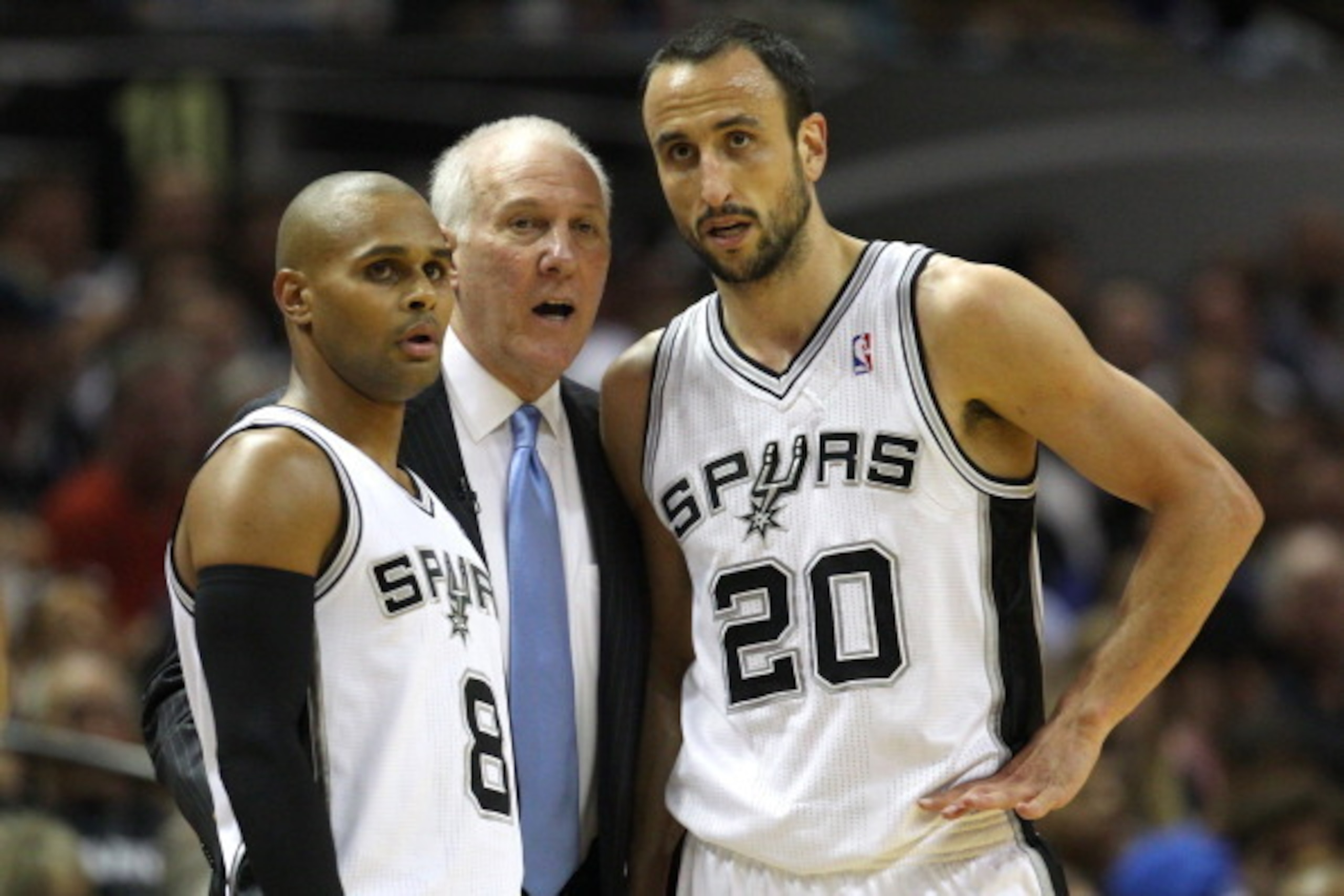 SAN ANTONIO, TX - MAY 21: Head coach Gregg Popovich of the San Antonio Spurs talks with Patty Mills #8 and Manu Ginobili #20 in the first half while taking on the Oklahoma City Thunder in Game Two of the Western Conference Finals during the 2014 NBA Play SAN ANTONIO, TX - MAY 21: Head coach Gregg Popovich of the San Antonio Spurs talks with Patty Mills #8 and Manu Ginobili #20 in the first half while taking on the Oklahoma City Thunder in Game Two of the Western Conference Finals during the 2014 NBA Play