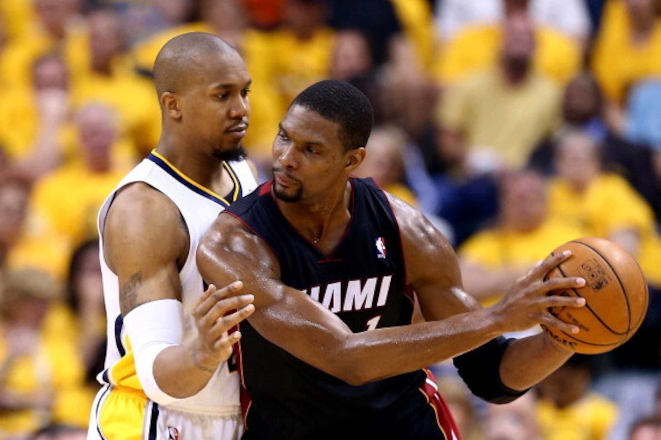 INDIANAPOLIS, IN - MAY 28: David West #21 of the Indiana Pacers defends against Chris Bosh #1 of the Miami Heat during Game Five of the Eastern Conference Finals of the 2014 NBA Playoffs at Bankers Life Fieldhouse on May 28, 2014 in Indianapolis, Indiana.