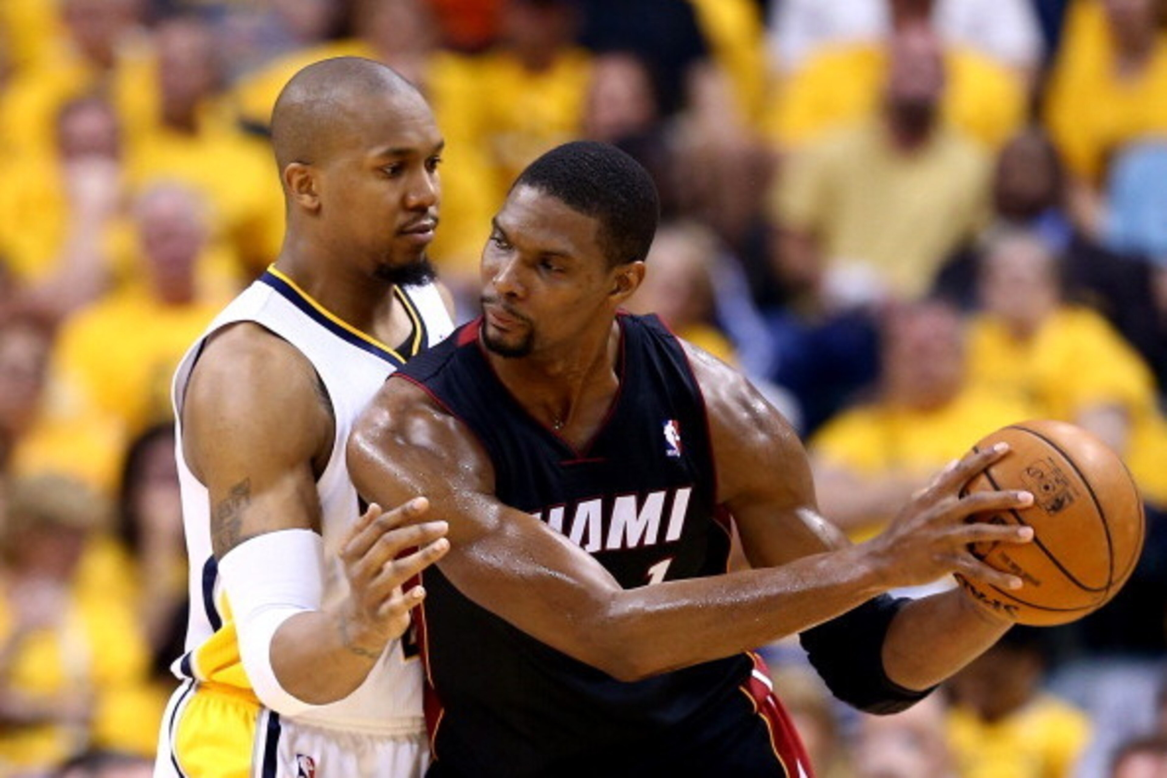 INDIANAPOLIS, IN - MAY 28: David West #21 of the Indiana Pacers defends against Chris Bosh #1 of the Miami Heat during Game Five of the Eastern Conference Finals of the 2014 NBA Playoffs at Bankers Life Fieldhouse on May 28, 2014 in Indianapolis, Indiana.