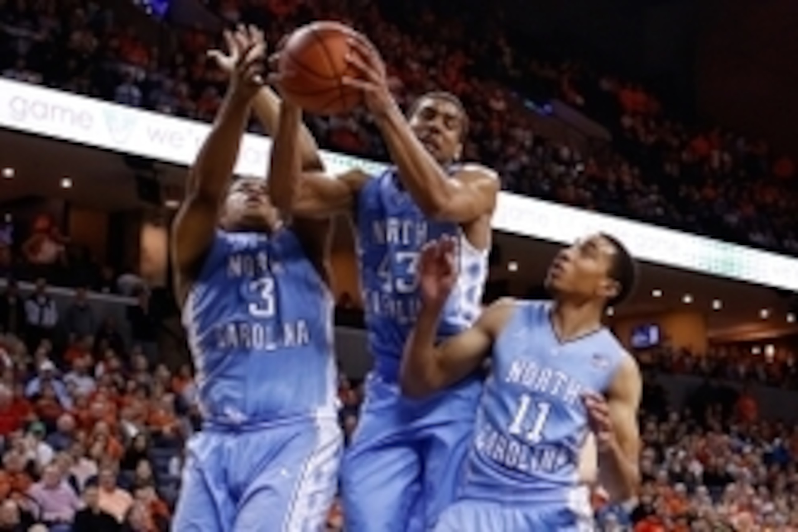 Jan 20, 2014; Charlottesville, VA, USA; North Carolina Tar Heels forward Kennedy Meeks (3), Tar Heels forward James Michael McAdoo (43), and Tar Heels forward Brice Johnson (11) reach for the ball against the Virginia Cavaliers at John Paul Jones Arena. M