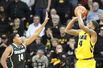 IOWA CITY, IA - JANUARY 28:  Guard Roy Devyn Marble #4 of the Iowa Hawkeyes takes a shot during the second half in front of guard Gary Harris #14 of the Michigan State Spartans on January 28, 2014 at Carver-Hawkeye Arena, in Iowa City, Iowa. (Photo by Mat
