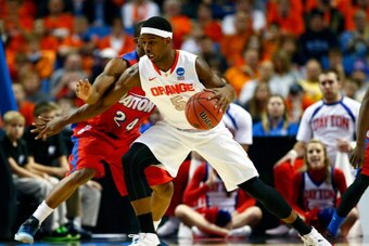 BUFFALO, NY - MARCH 22: C.J. Fair #5 of the Syracuse Orange handles the ball as Jordan Sibert #24 of the Dayton Flyers defends during the third round of the 2014 NCAA Men's Basketball Tournament at the First Niagara Center on March 22, 2014 in Buffalo, Ne