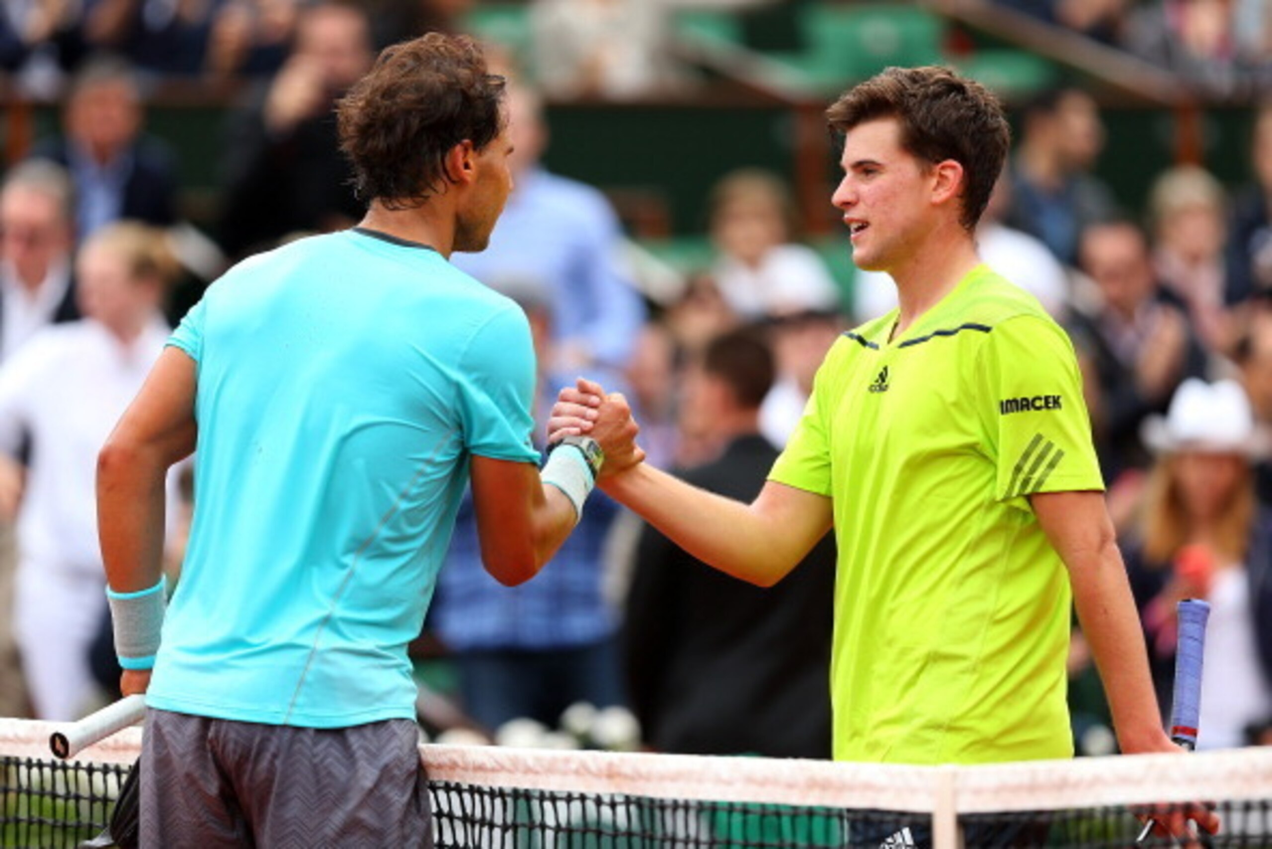 PARIS, FRANCE - MAY 29:  Rafael Nadal of Spain shakes hands with Dominic Thiem of Austria at the net after their men's singles match on day five of the French Open at Roland Garros on May 29, 2014 in Paris, France.  (Photo by Clive Brunskill/Getty Images)