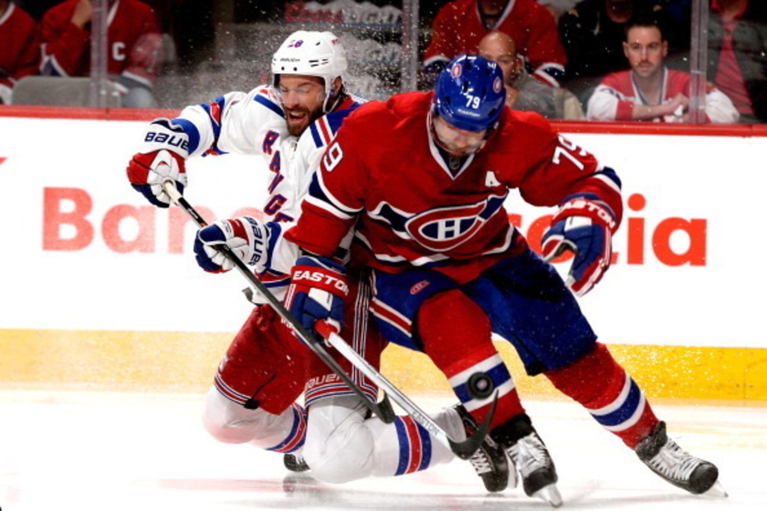 MONTREAL, QC - MAY 27: Dominic Moore #28 of the New York Rangers and Andrei Markov #79 of the Montreal Canadiens battle for the puck during Game Five of the Eastern Conference Final in the 2014 NHL Stanley Cup Playoffs at Bell Centre on May 27, 2014 in Mo