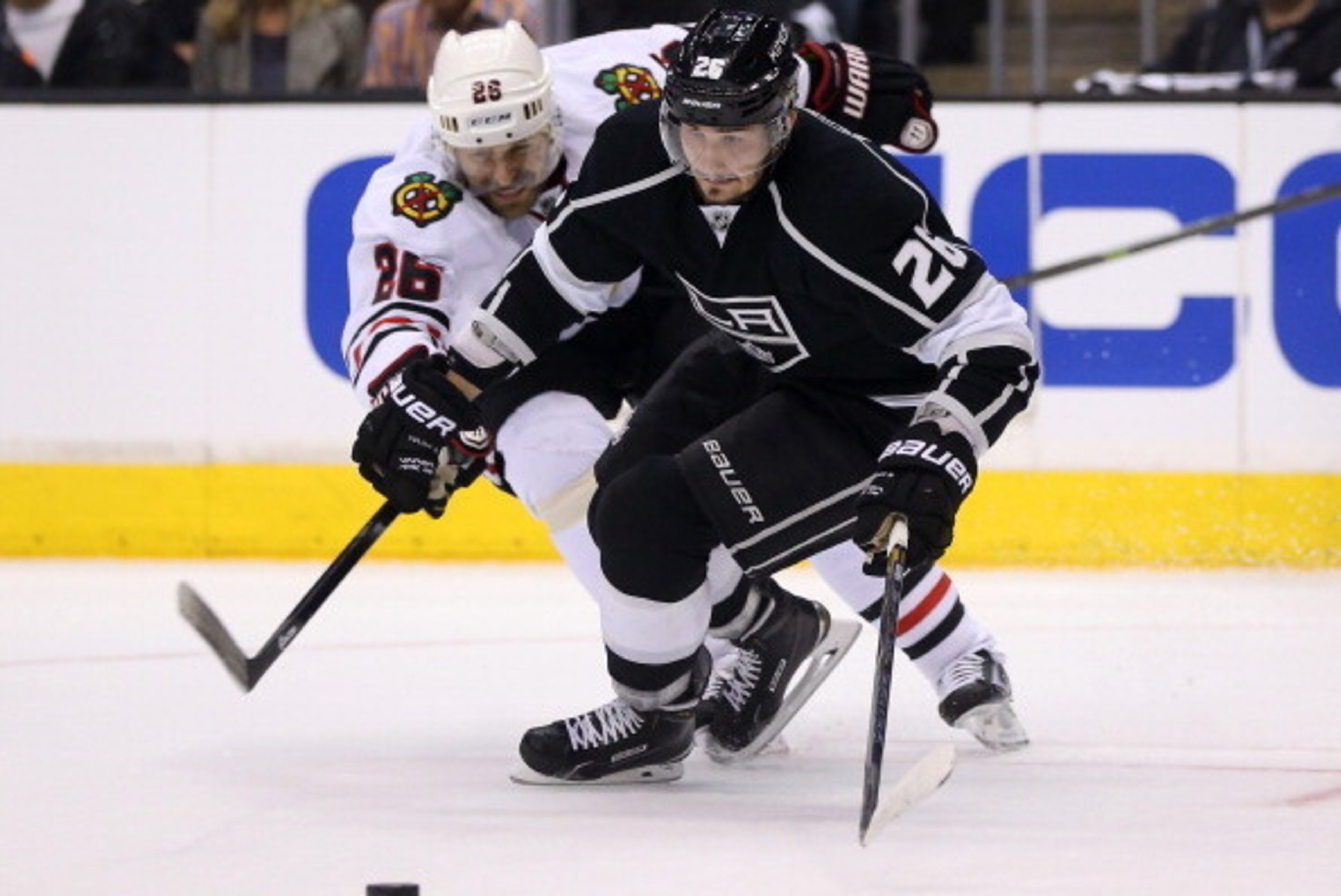 LOS ANGELES, CA - MAY 26:  Slava Voynov #26 of the Los Angeles Kings and Michal Handzus #26 of the Chicago Blackhawks battle for the puck in Game Four of the Western Conference Final during the 2014 Stanley Cup Playoffs at Staples Center on May 26, 2014 i