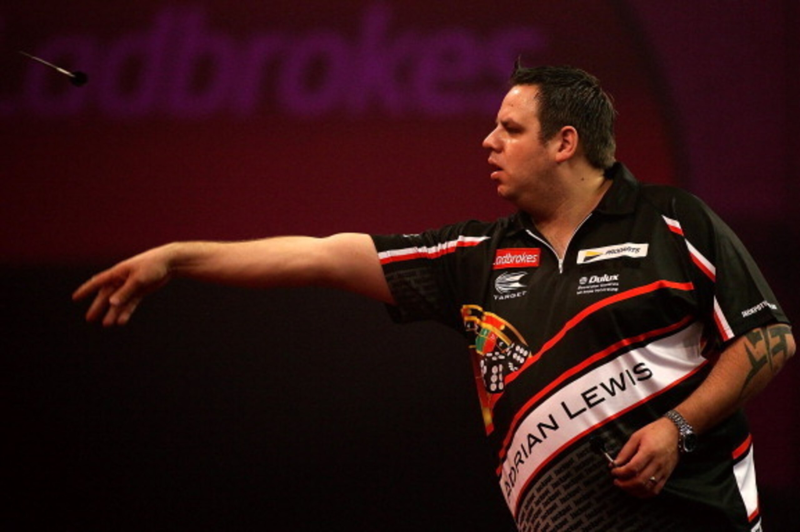 LONDON, ENGLAND - DECEMBER 30: Adrian Lewis of England in action during his semi final match against Michael van Gerwen of The Netherlands on day fifteen of the Ladbrokes.com World Darts Championship at Alexandra Palace on December 30, 2013 in London, Eng LONDON, ENGLAND - DECEMBER 30: Adrian Lewis of England in action during his semi final match against Michael van Gerwen of The Netherlands on day fifteen of the Ladbrokes.com World Darts Championship at Alexandra Palace on December 30, 2013 in London, Eng