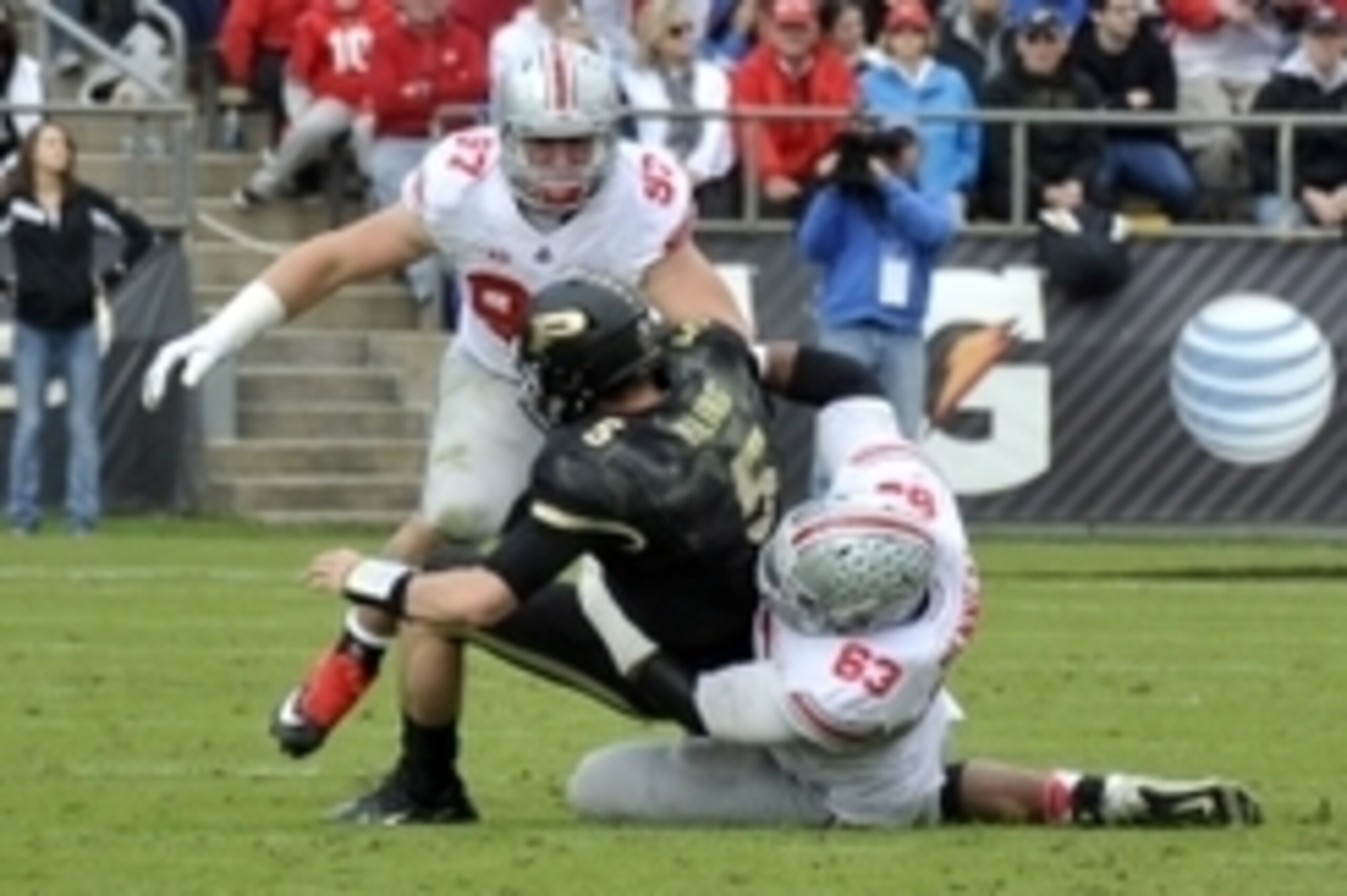 Nov 2, 2013; West Lafayette, IN, USA;  Purdue Boilermakers quarterback Danny Etling (5) is sacked by Ohio State Buckeyes defensive lineman Michael Bennett (63) and defensive lineman Joey Bosa (97) in the first half at Ross Ade Stadium. Mandatory Credit: S