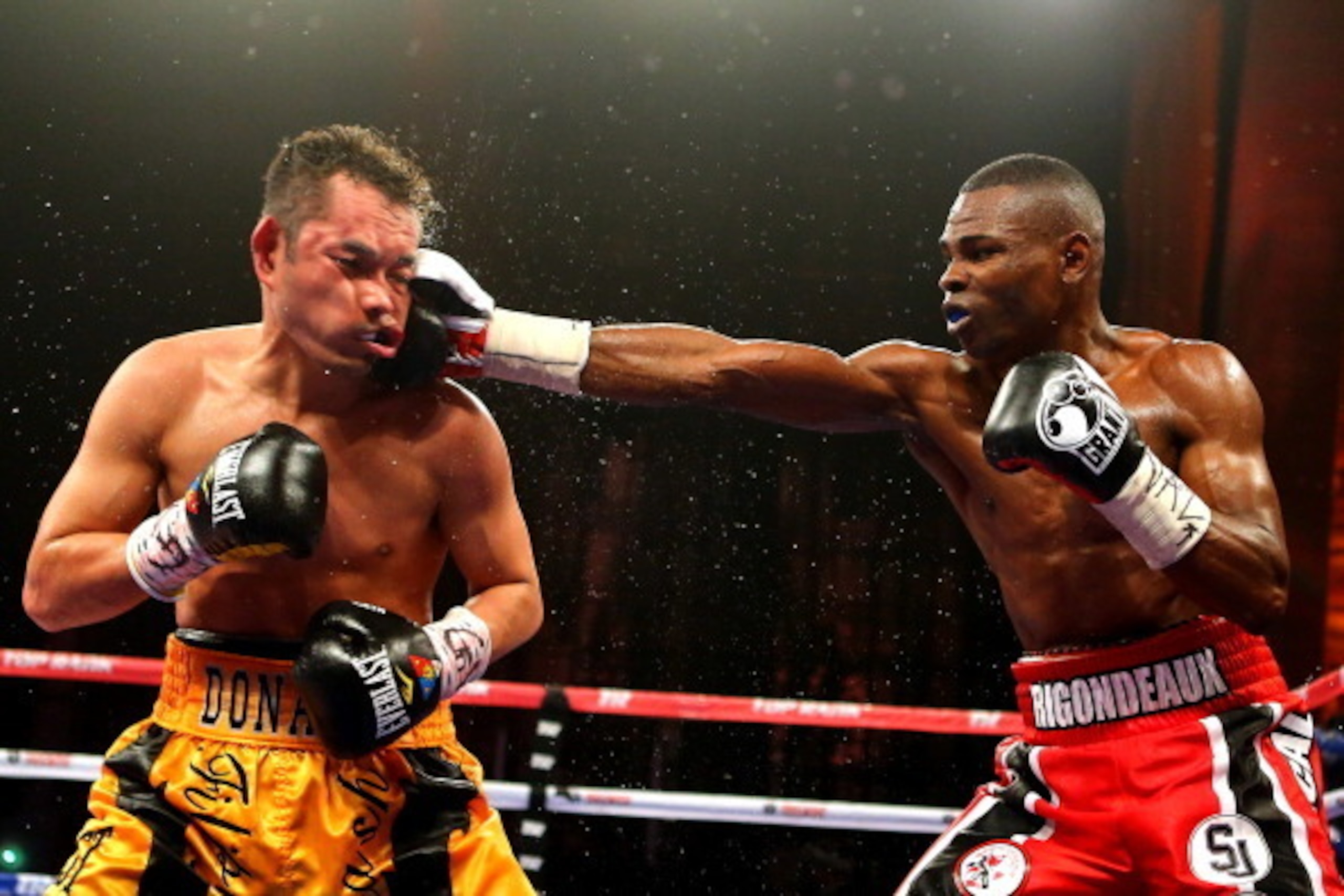 NEW YORK, NY - APRIL 13:  Guillermo Rigondeaux punches Nonito Donaire during their WBO/WBA junior featherweight title unification bout at Radio City Music Hall on April 13, 2013 in New York City.  (Photo by Al Bello/Getty Images)